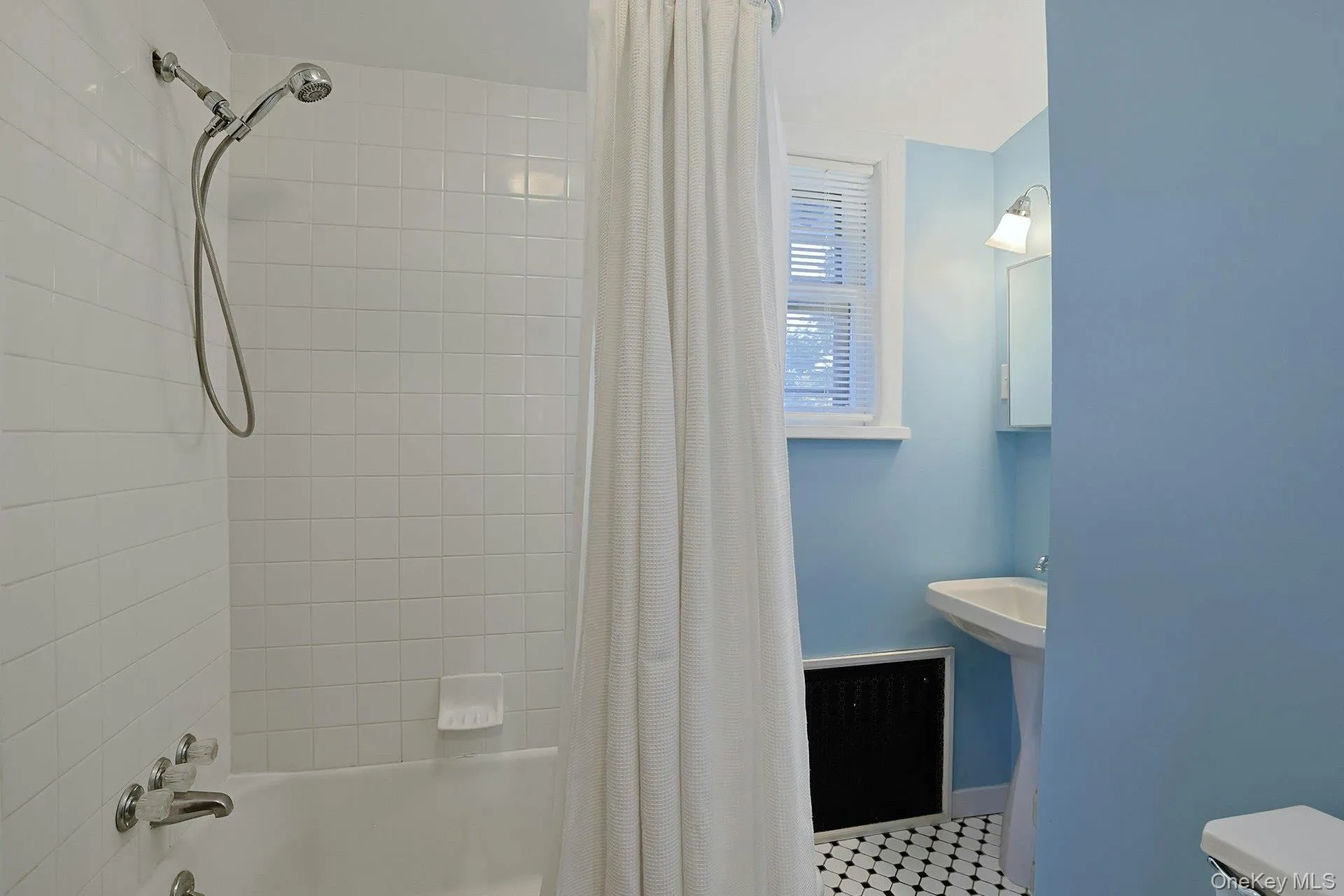 Full bath off the hallway features a practical layout and easy access from the bedrooms. Full bath off the hallway features a practical layout and easy access from the bedrooms.