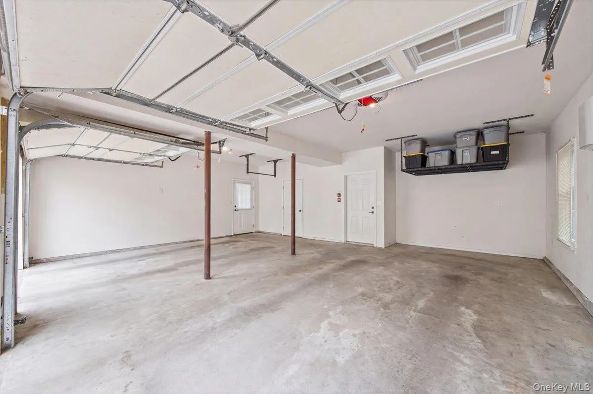 Two car garage with additional storage space. Also features EV charger. Two car garage with additional storage space. Also features EV charger.