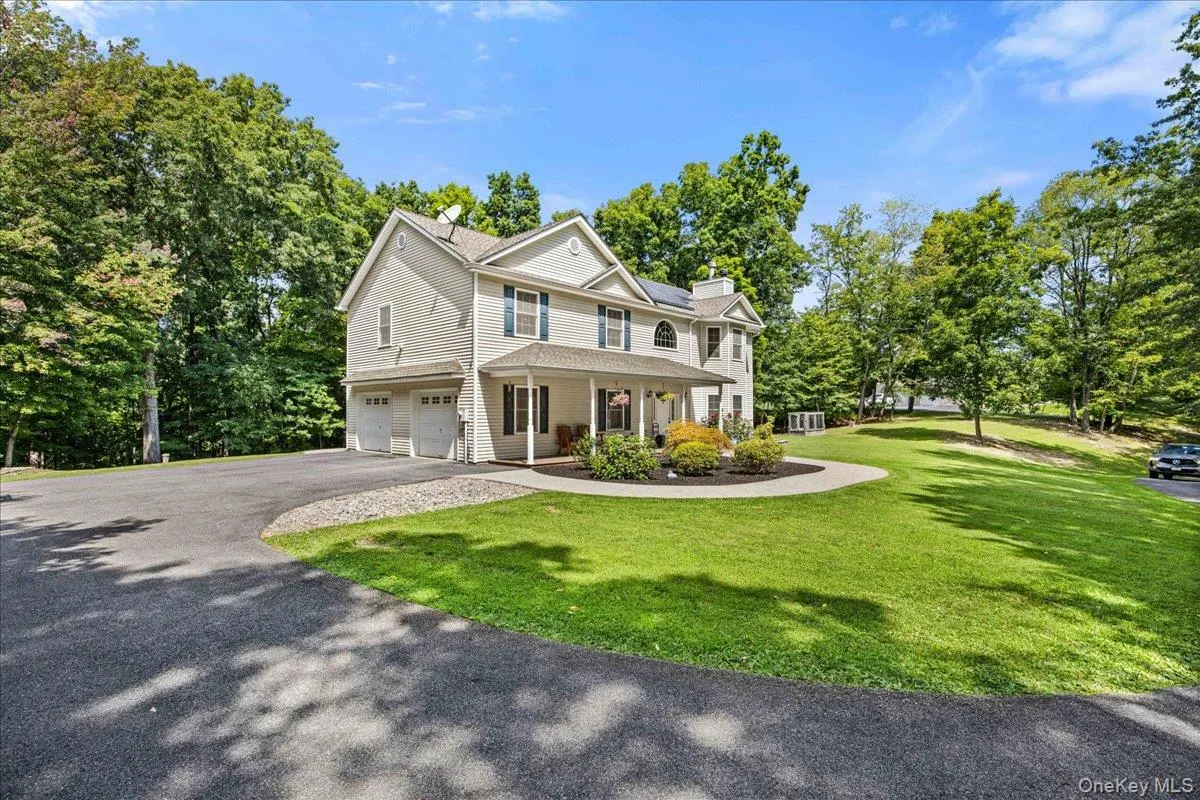 Ample parking, 2 car garage and covered front porch. Ample parking, 2 car garage and covered front porch.