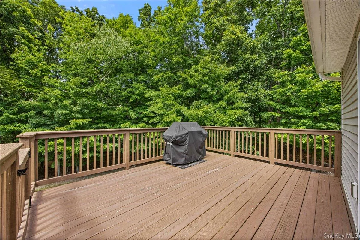 Rear deck sits high over the property and provides stairs to the lower patio. Rear deck sits high over the property and provides stairs to the lower patio.