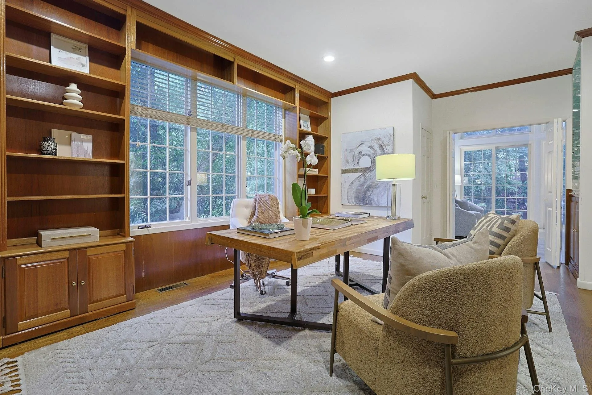 Another view of the impressive office highlights the extensive custom built-ins, large window overlooking the greenery and ample room for a substantial desk and comfortable seating. Another view of the impressive office highlights the extensive custom built-ins, large window overlooking the greenery and ample room for a substantial desk and comfortable seating.