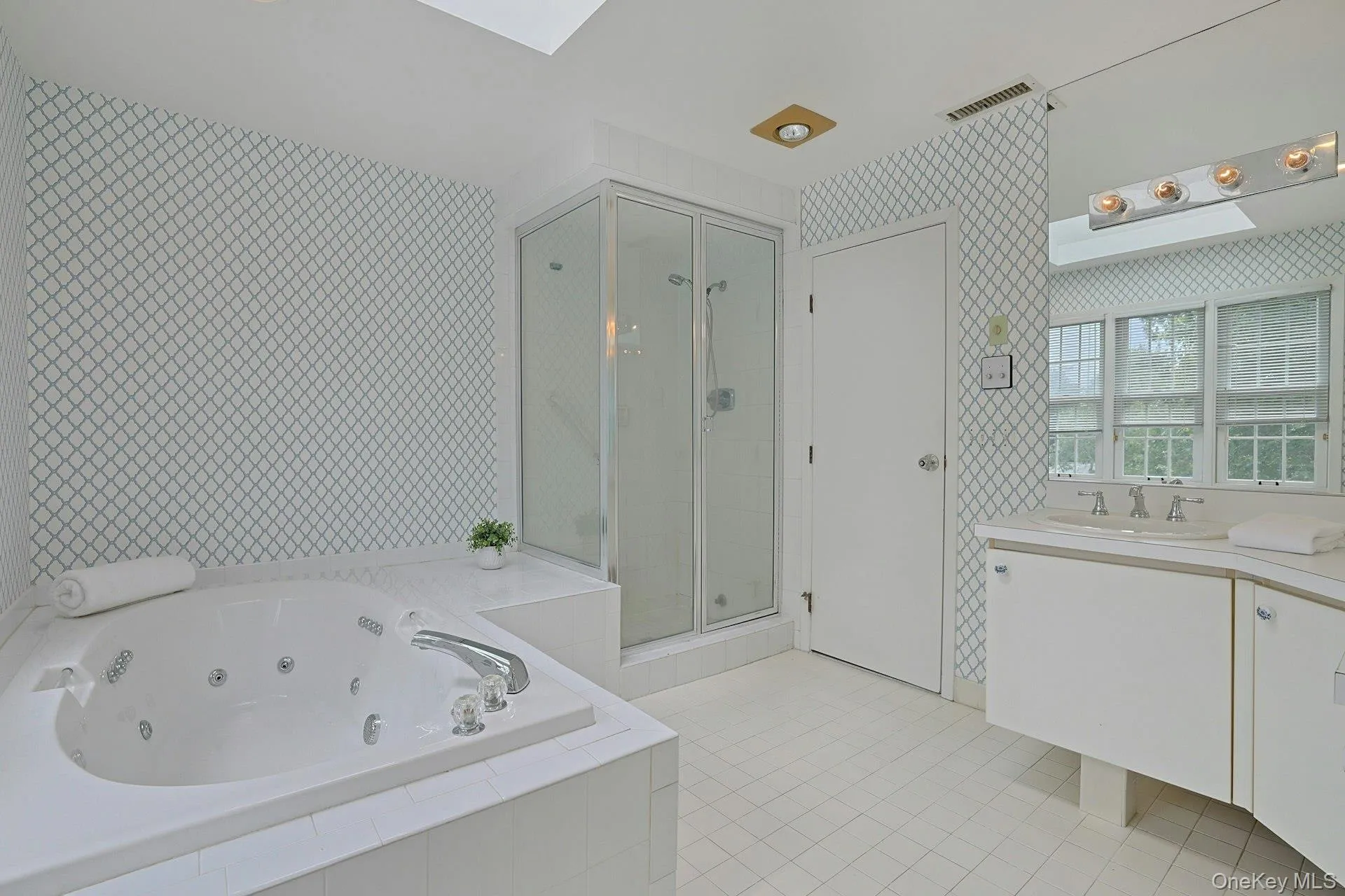 Another view of the generously sized primary bath showcases the tub, separate glass-enclosed shower and excellent storage. Another view of the generously sized primary bath showcases the tub, separate glass-enclosed shower and excellent storage.
