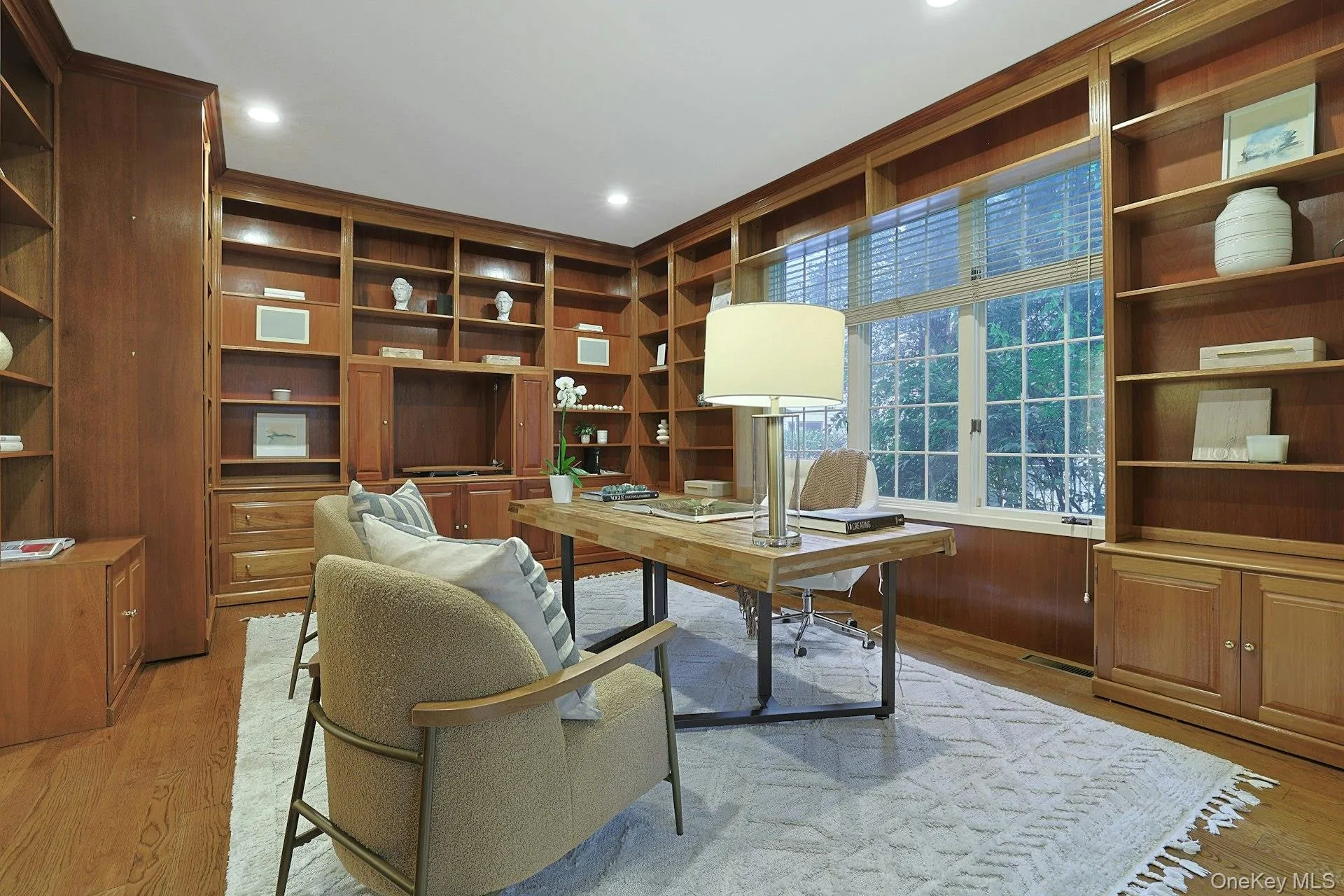 Handsome private office is wrapped in custom built-in bookshelves and cabinetry, creating a sophisticated and highly functional work-from-home space. Handsome private office is wrapped in custom built-in bookshelves and cabinetry, creating a sophisticated and highly functional work-from-home space.
