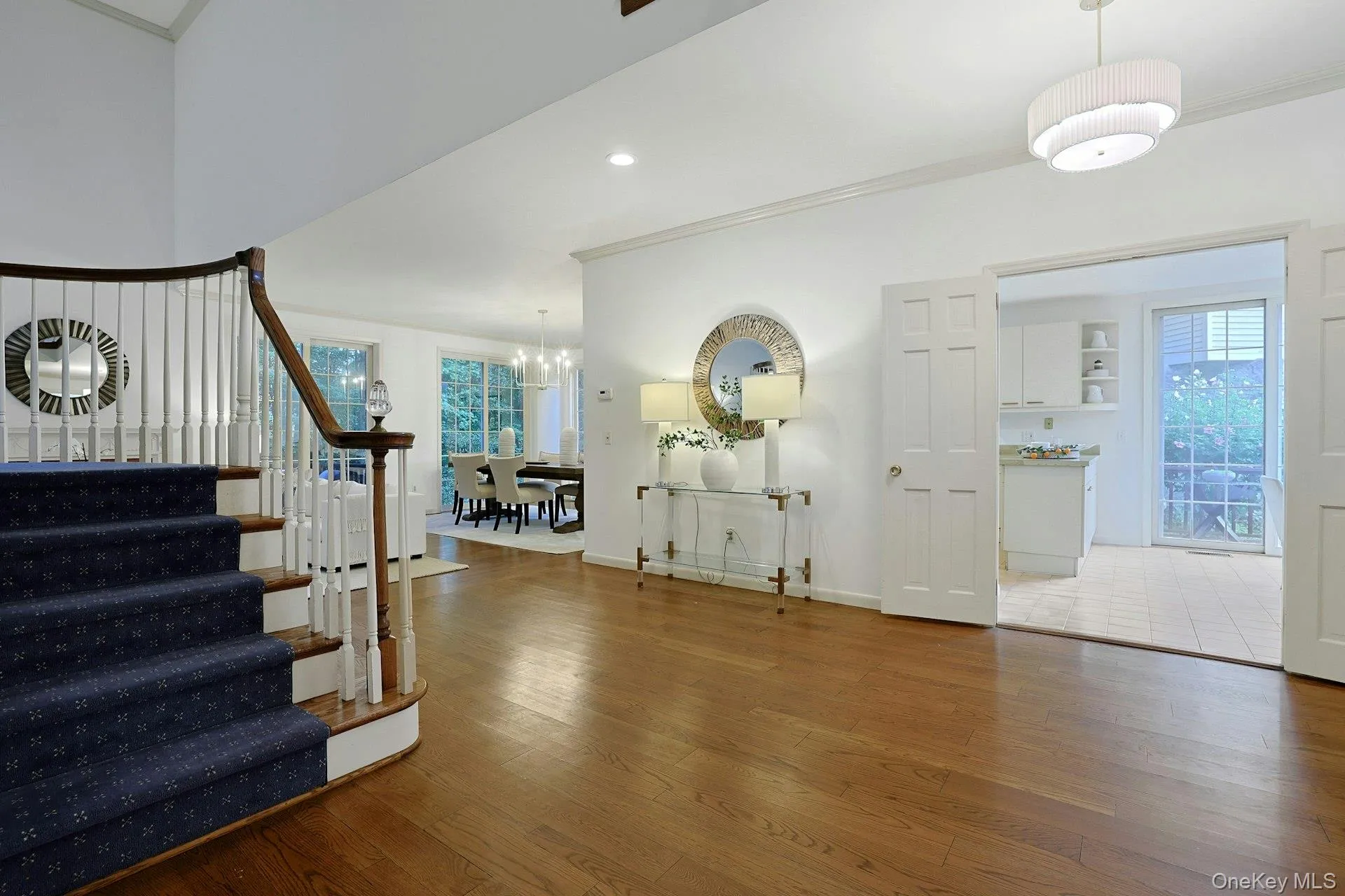 Welcoming foyer opens to the light-filled main level and showcases the home’s generous proportions and open flow. Double doors to the kitchen on the right. Welcoming foyer opens to the light-filled main level and showcases the home’s generous proportions and open flow. Double doors to the kitchen on the right.