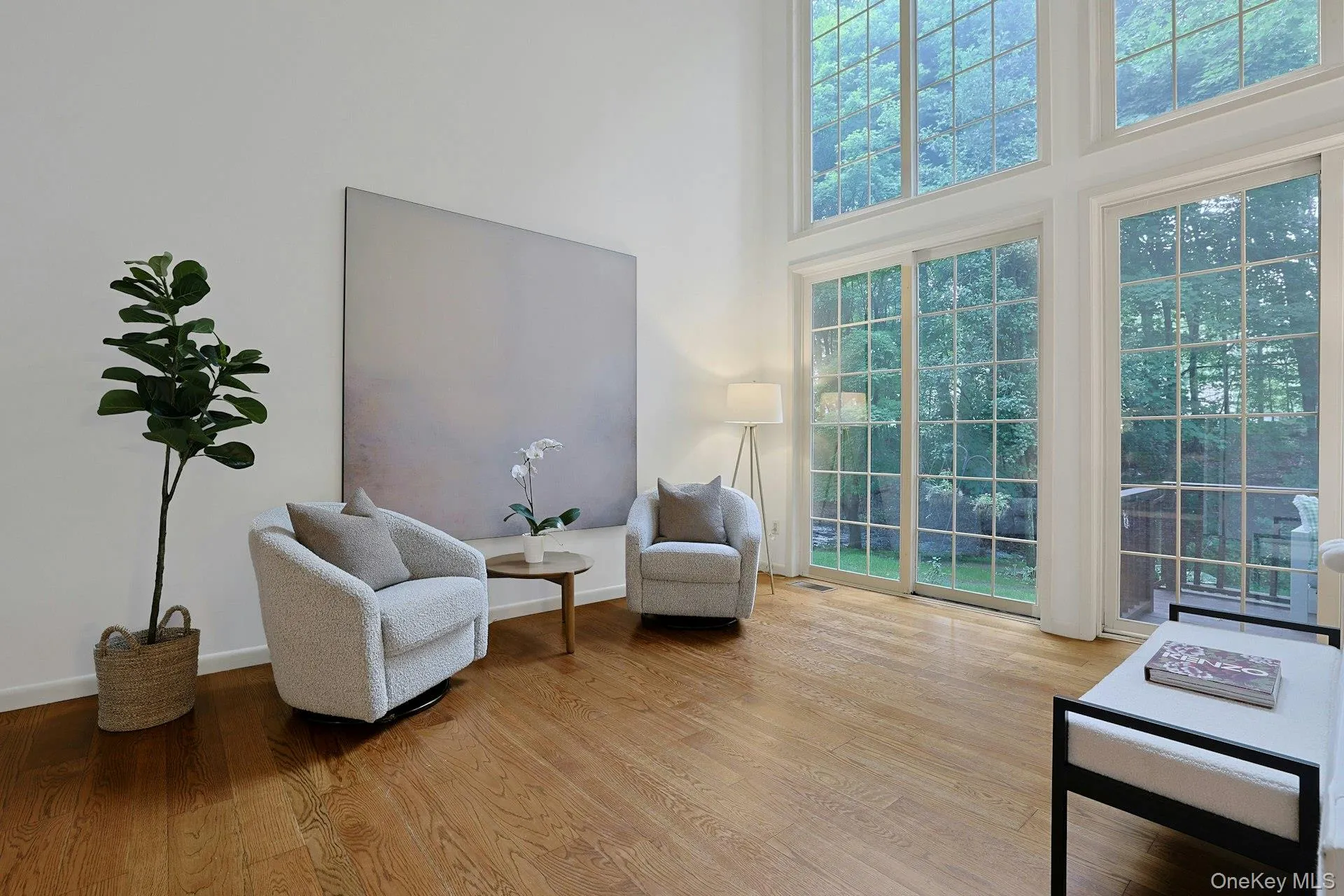 An additional sitting area within the expansive double-height living room demonstrates the remarkable flexibility of this space. An additional sitting area within the expansive double-height living room demonstrates the remarkable flexibility of this space.