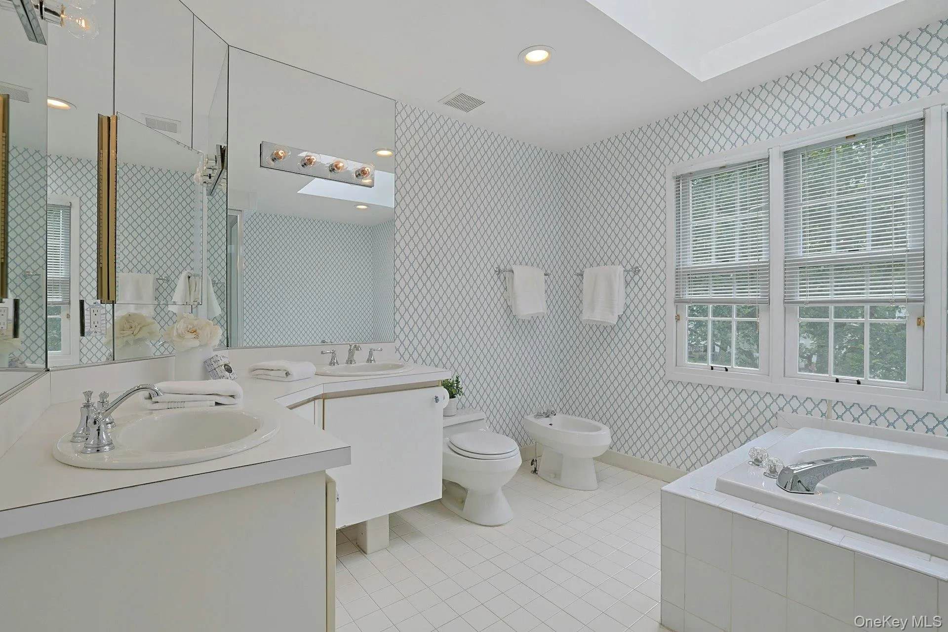 Bright primary bath features a double vanity, large soaking tub, separate Jacuzzi tub and abundant natural light from a skylight. Bright primary bath features a double vanity, large soaking tub, separate Jacuzzi tub and abundant natural light from a skylight.