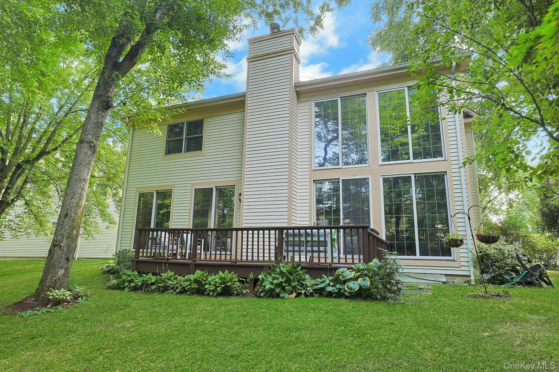 Rear view showcases the home’s dramatic architecture, soaring windows and deck, all set against a beautiful natural backdrop. Rear view showcases the home’s dramatic architecture, soaring windows and deck, all set against a beautiful natural backdrop.