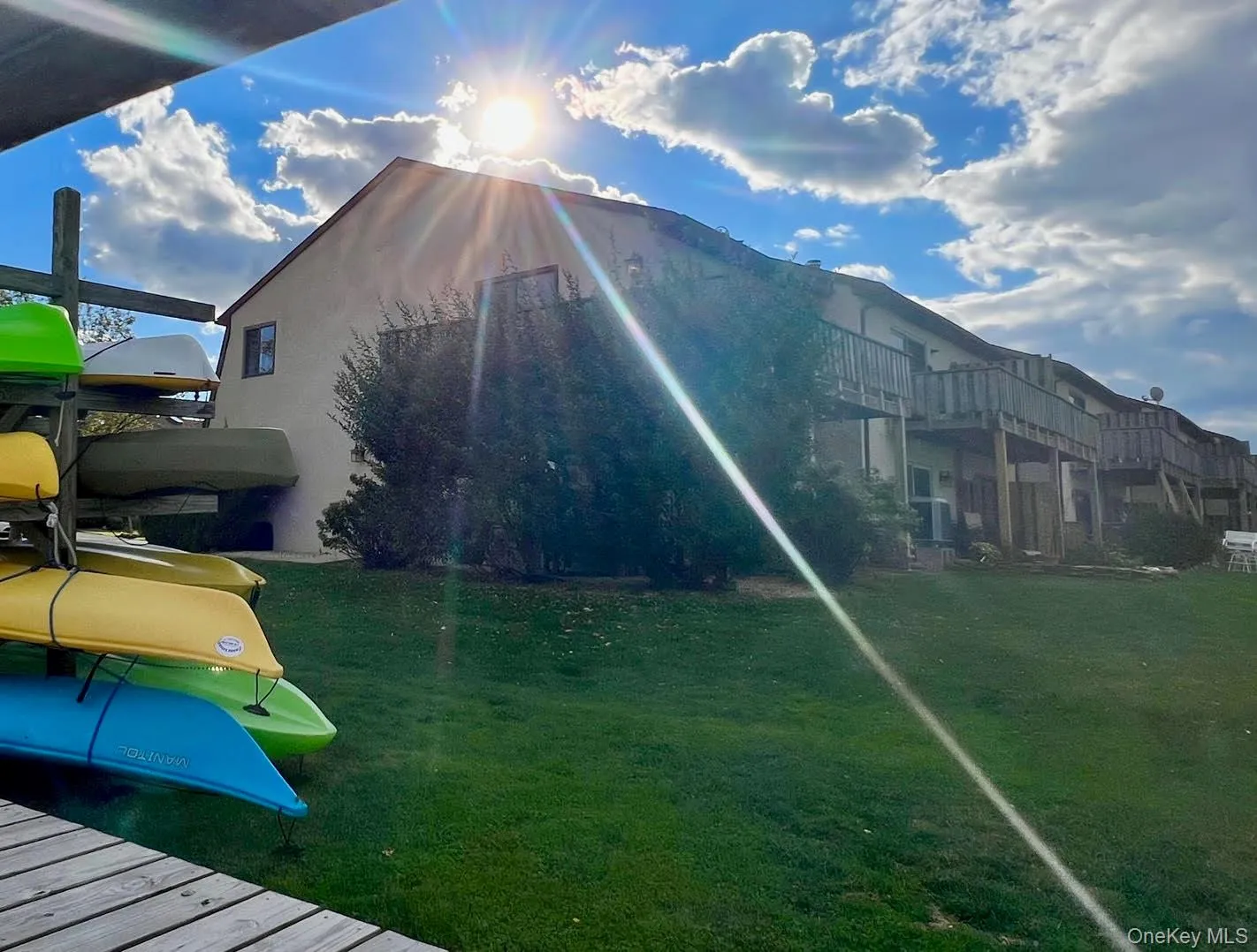 Sun-kissed View of Corner Unit over vast Lawn and Kayaks! Sun-kissed View of Corner Unit over vast Lawn and Kayaks!