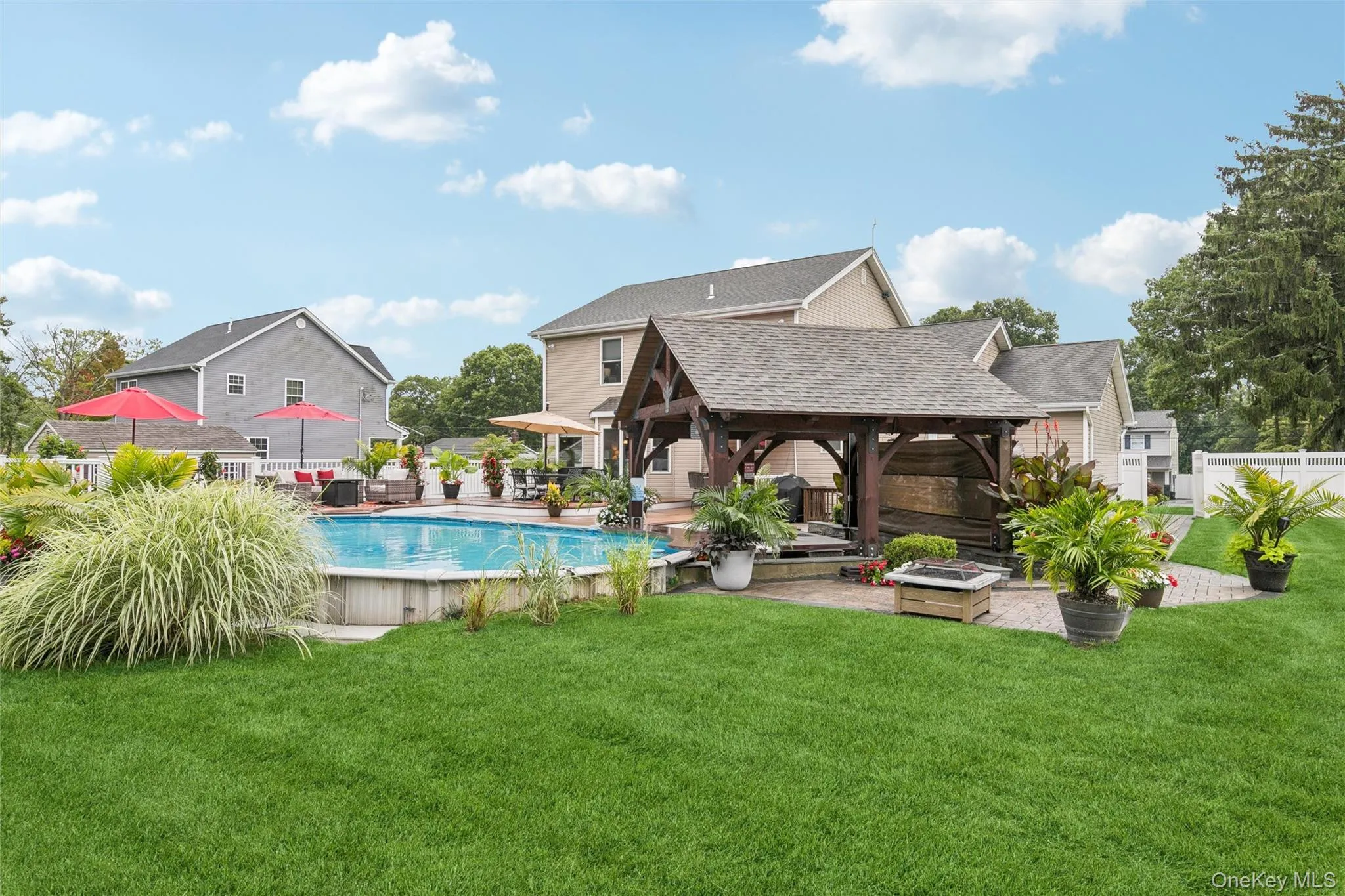 Semi In-Groud Pool Highlights the Vibrant Landscaping and Deck Surrounding Semi In-Groud Pool Highlights the Vibrant Landscaping and Deck Surrounding