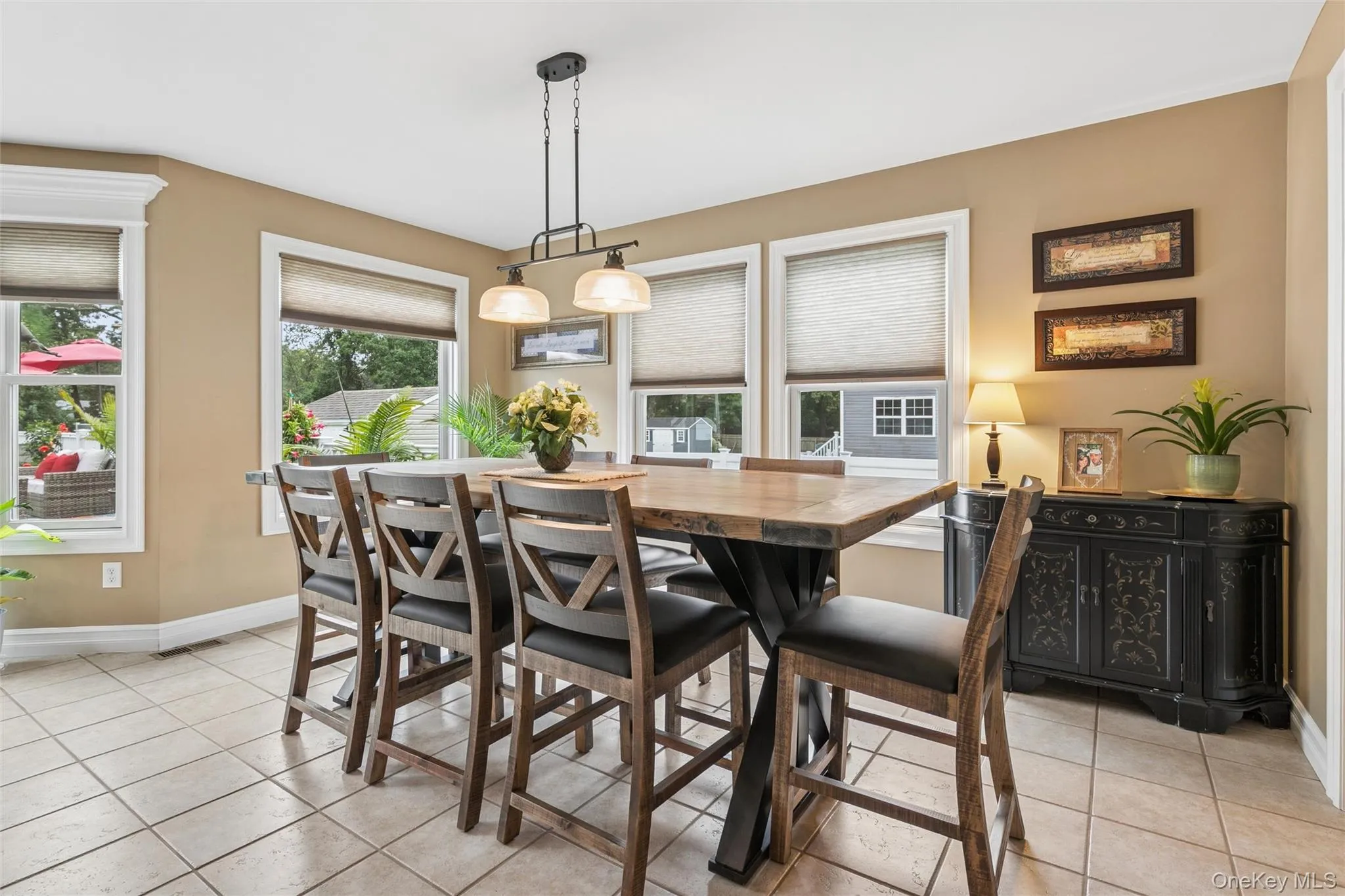 Dining Area Surrounded By Oversized Windows and Sliding Glass Doors Dining Area Surrounded By Oversized Windows and Sliding Glass Doors
