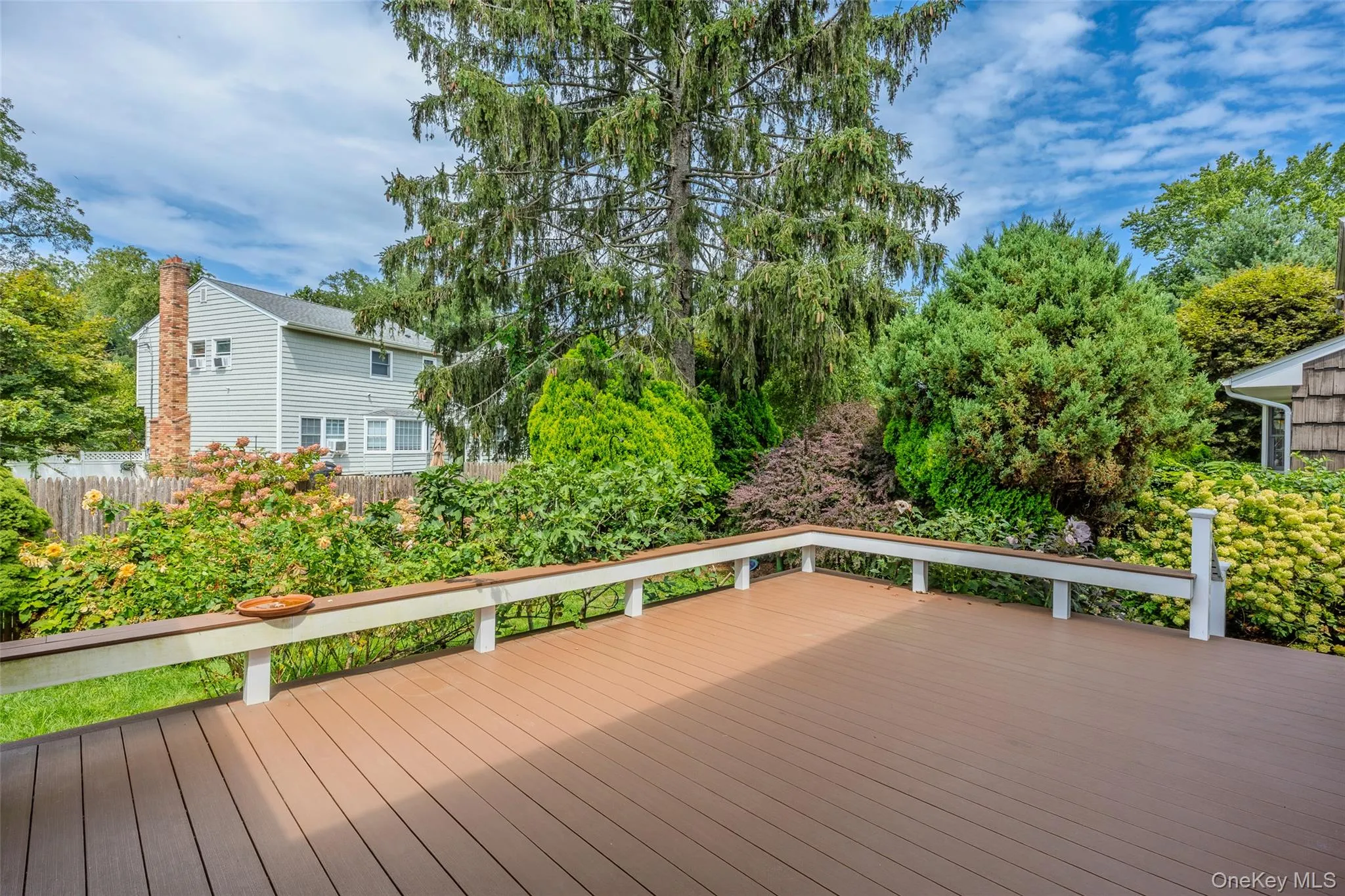 Large deck with view of yard and plantings Large deck with view of yard and plantings