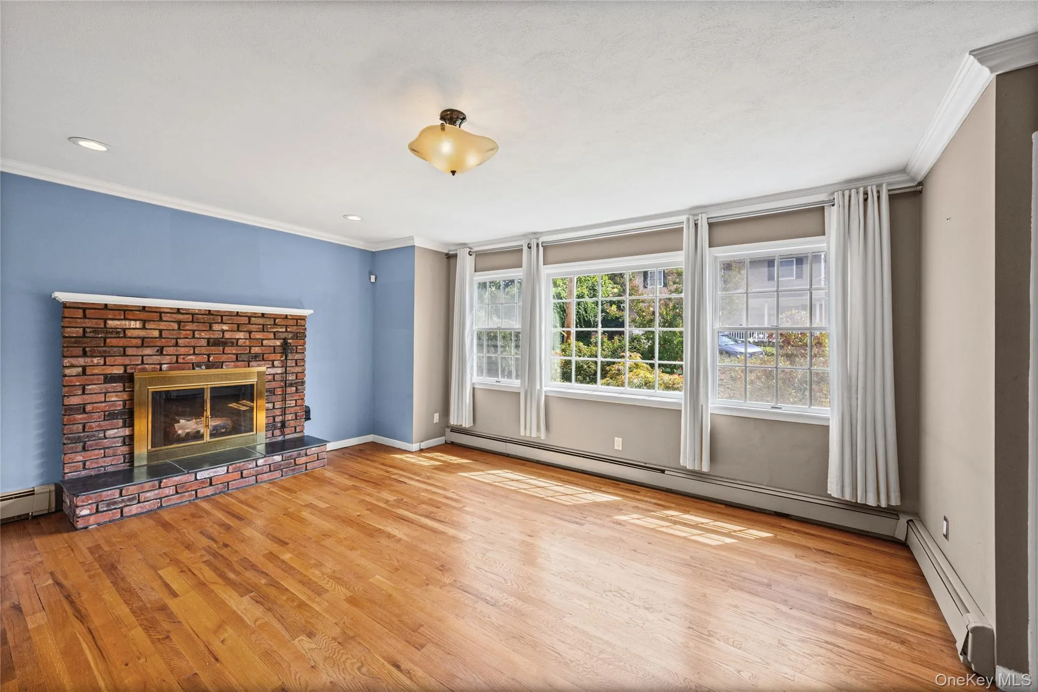 Large windows in living room facing front yard Large windows in living room facing front yard