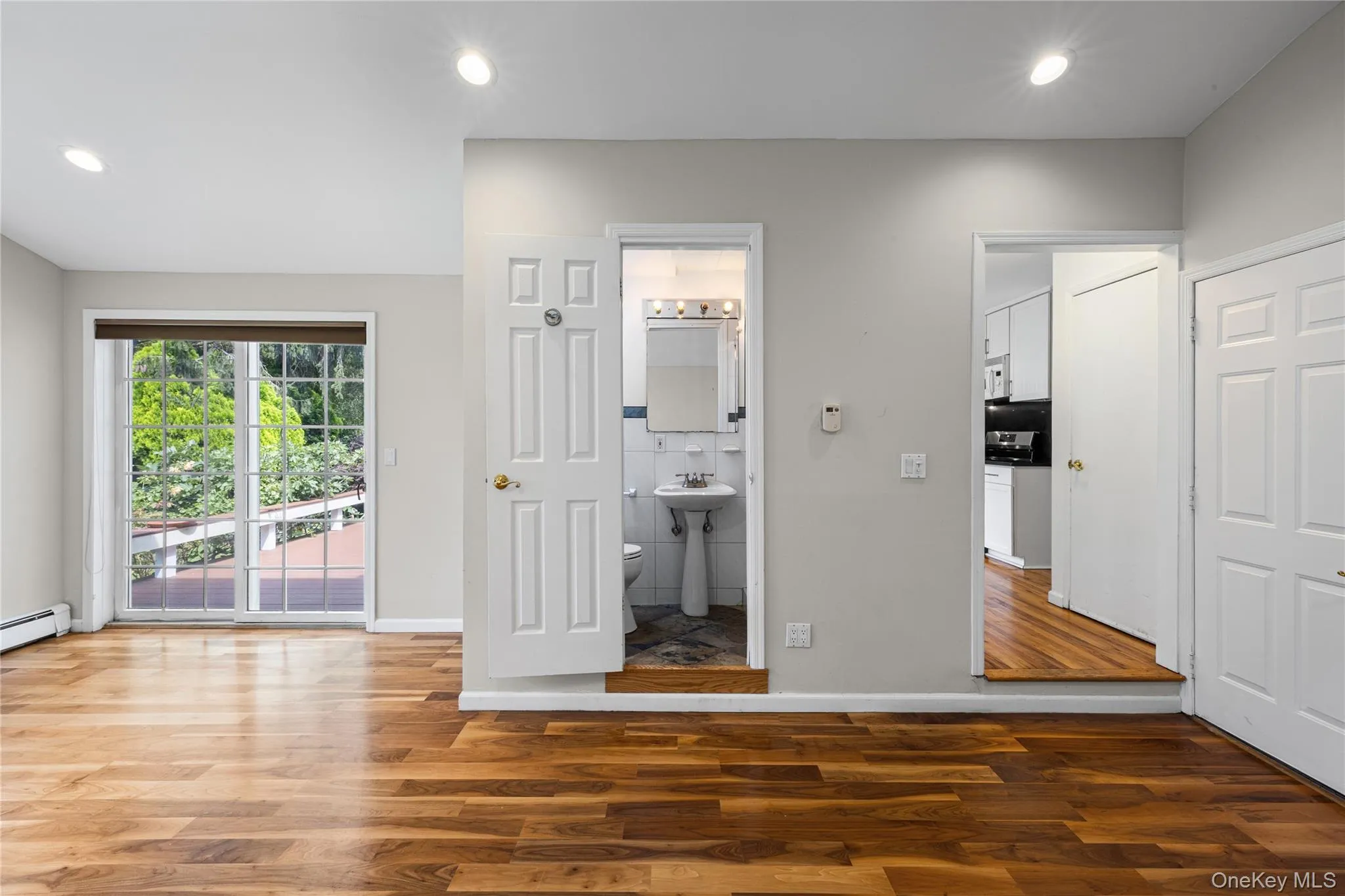 Large family room with sliders to the deck, vaulted ceiling and a full bathroom Large family room with sliders to the deck, vaulted ceiling and a full bathroom