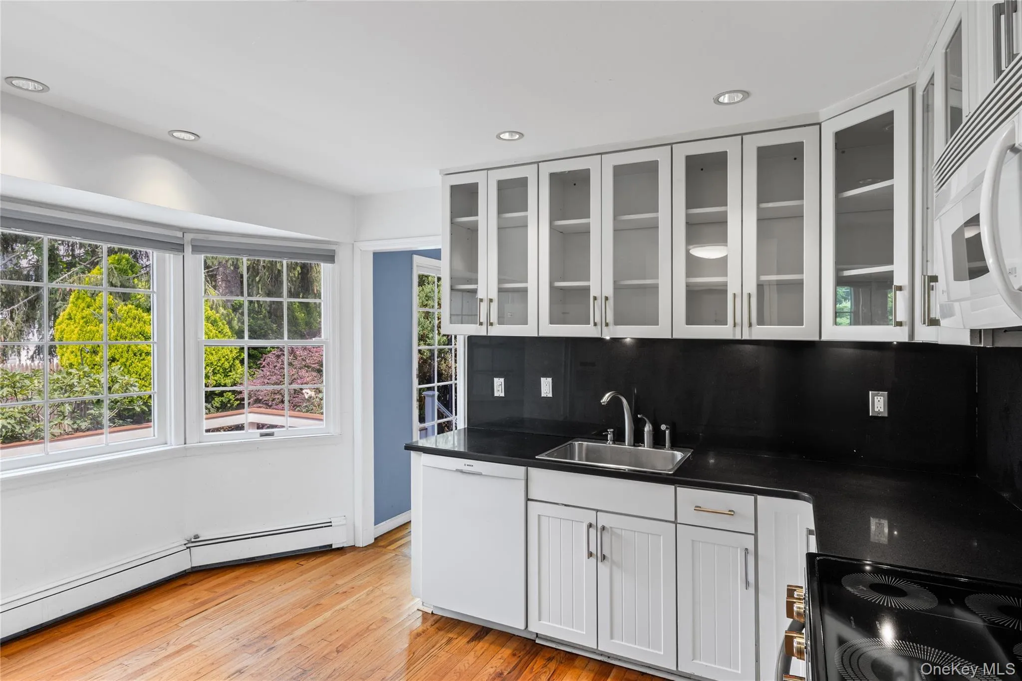 Light and bright kitchen with white cabinets and granite counters Light and bright kitchen with white cabinets and granite counters