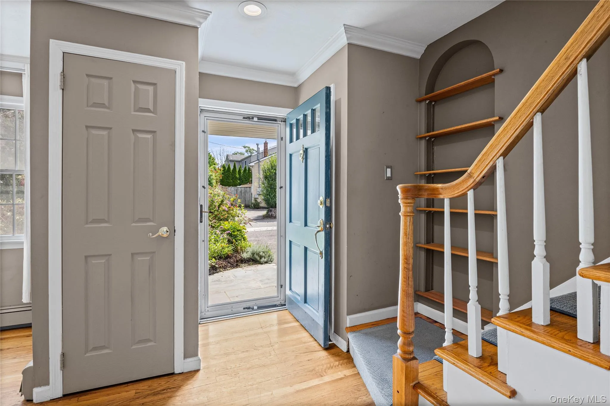 Front door entry with two hall closets and staircase to upstairs Front door entry with two hall closets and staircase to upstairs