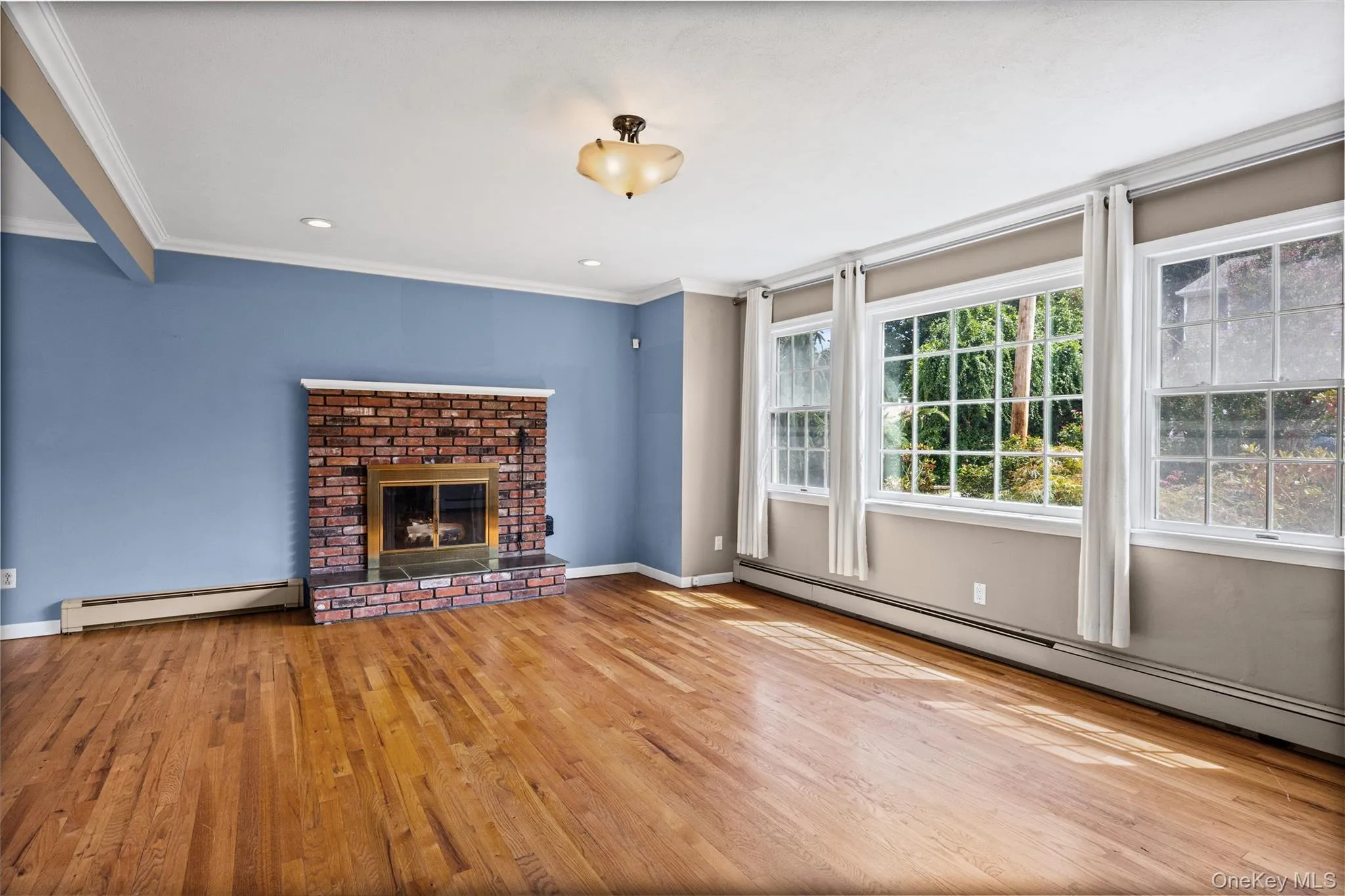 Large light and bright living room with wood burning fireplace Large light and bright living room with wood burning fireplace
