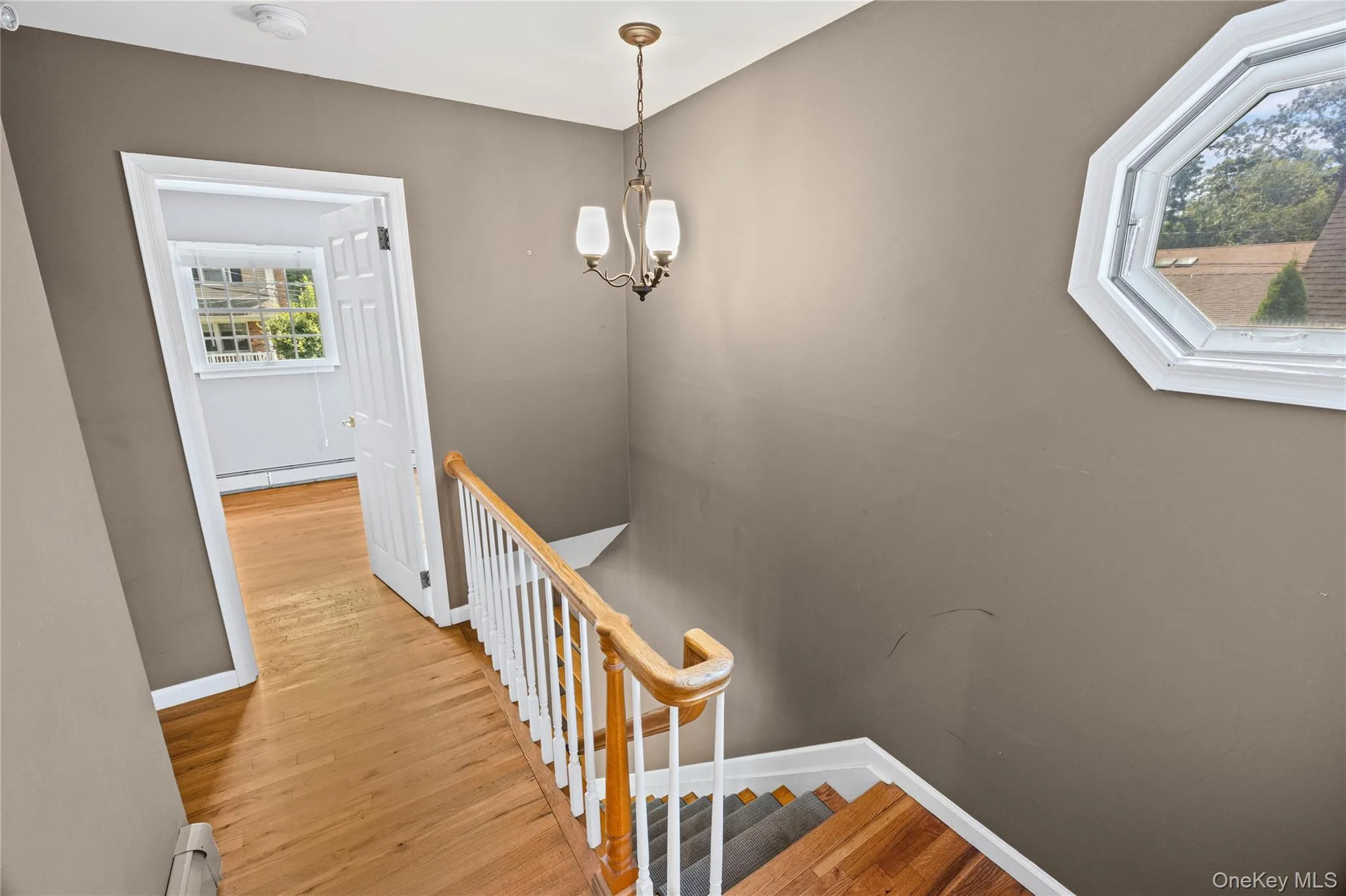 Staircase to the upstairs bedrooms and full bath Staircase to the upstairs bedrooms and full bath