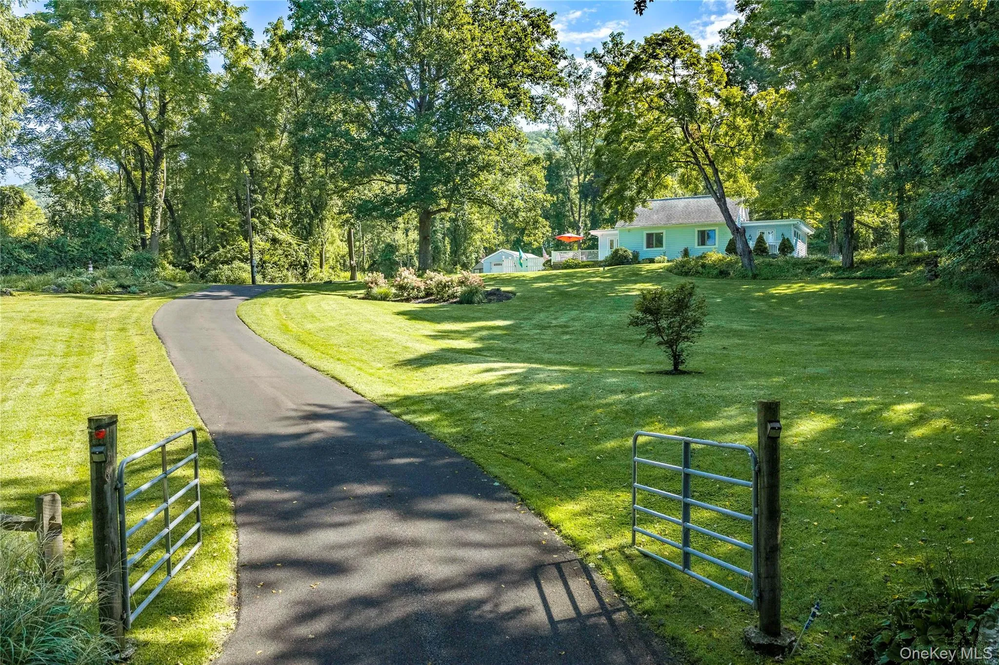 A long paved driveway leads to the home, which sits high and well back from the road. A long paved driveway leads to the home, which sits high and well back from the road.