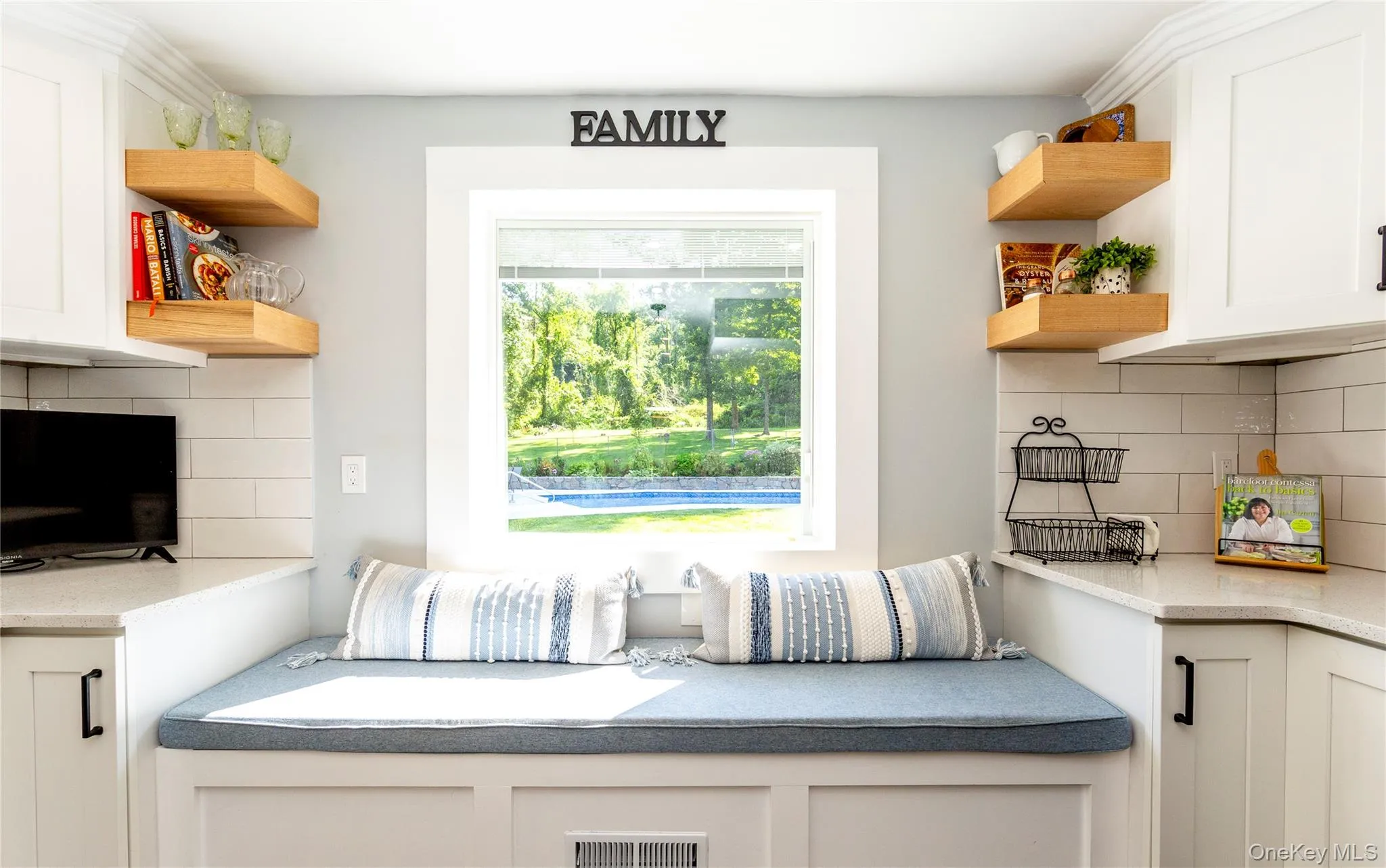 A charming picture window with bench seating and storage below. The view of the pool from the kitchen is so picturesque, it feels like a living work of art. A charming picture window with bench seating and storage below. The view of the pool from the kitchen is so picturesque, it feels like a living work of art.