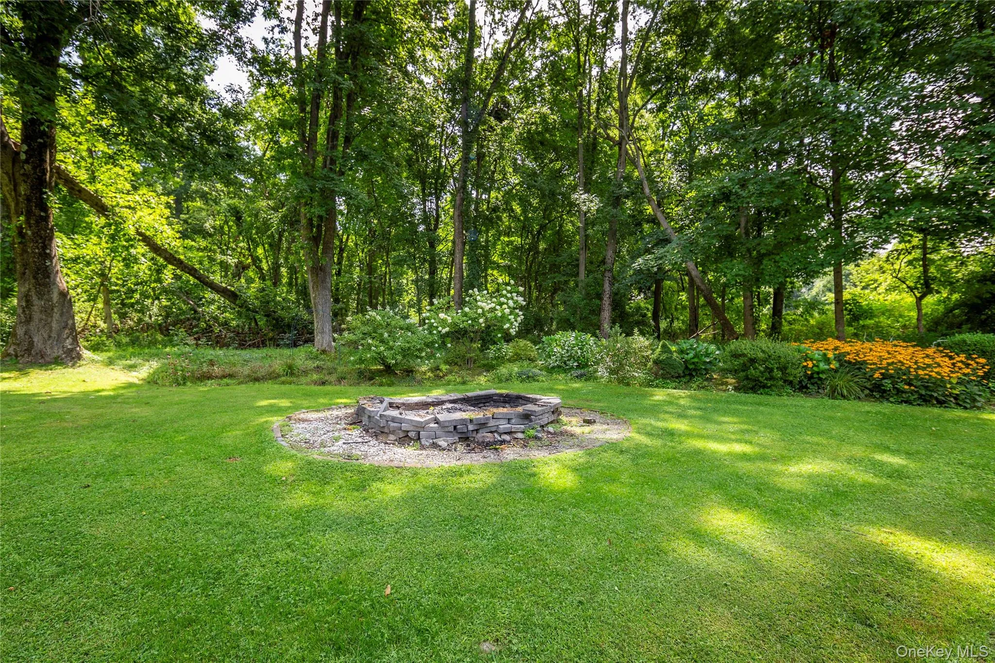 Beyond the gate, a custom circular fire pit creates a wonderful gathering place beneath the stars. Beyond the gate, a custom circular fire pit creates a wonderful gathering place beneath the stars.