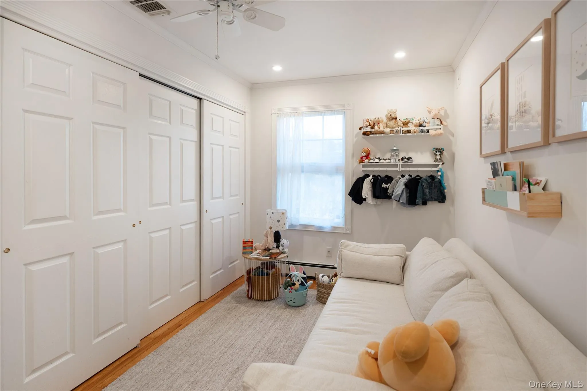 Living area with visible vents, crown molding, ceiling fan, wood finished floors, and recessed lighting Living area with visible vents, crown molding, ceiling fan, wood finished floors, and recessed lighting