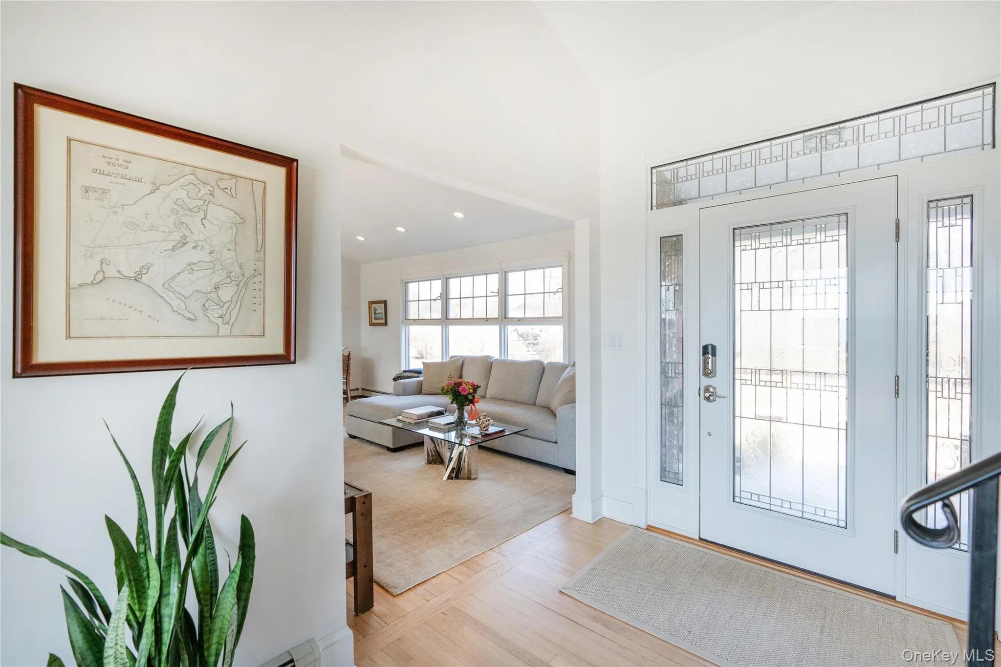 Entryway featuring light wood-type flooring and high vaulted ceiling Entryway featuring light wood-type flooring and high vaulted ceiling
