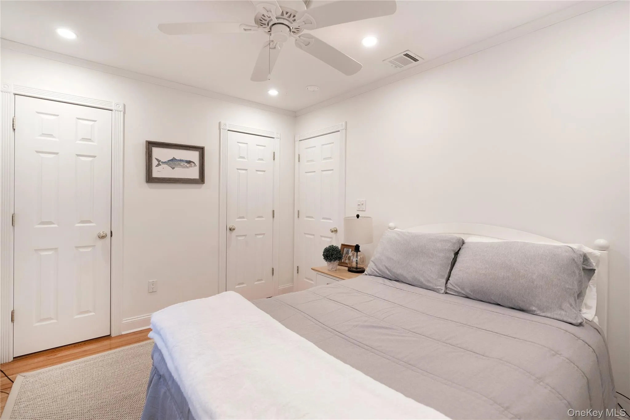 Bedroom with recessed lighting, visible vents, light wood-style floors, and crown molding Bedroom with recessed lighting, visible vents, light wood-style floors, and crown molding