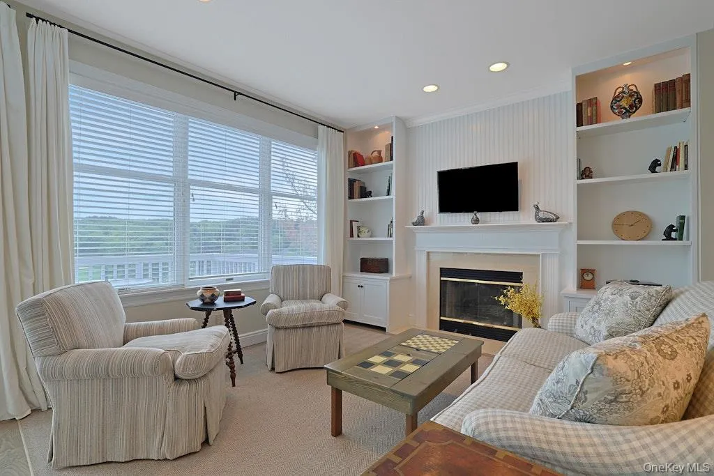 Family room with gas fireplace and built in bookcase with beautiful views Family room with gas fireplace and built in bookcase with beautiful views