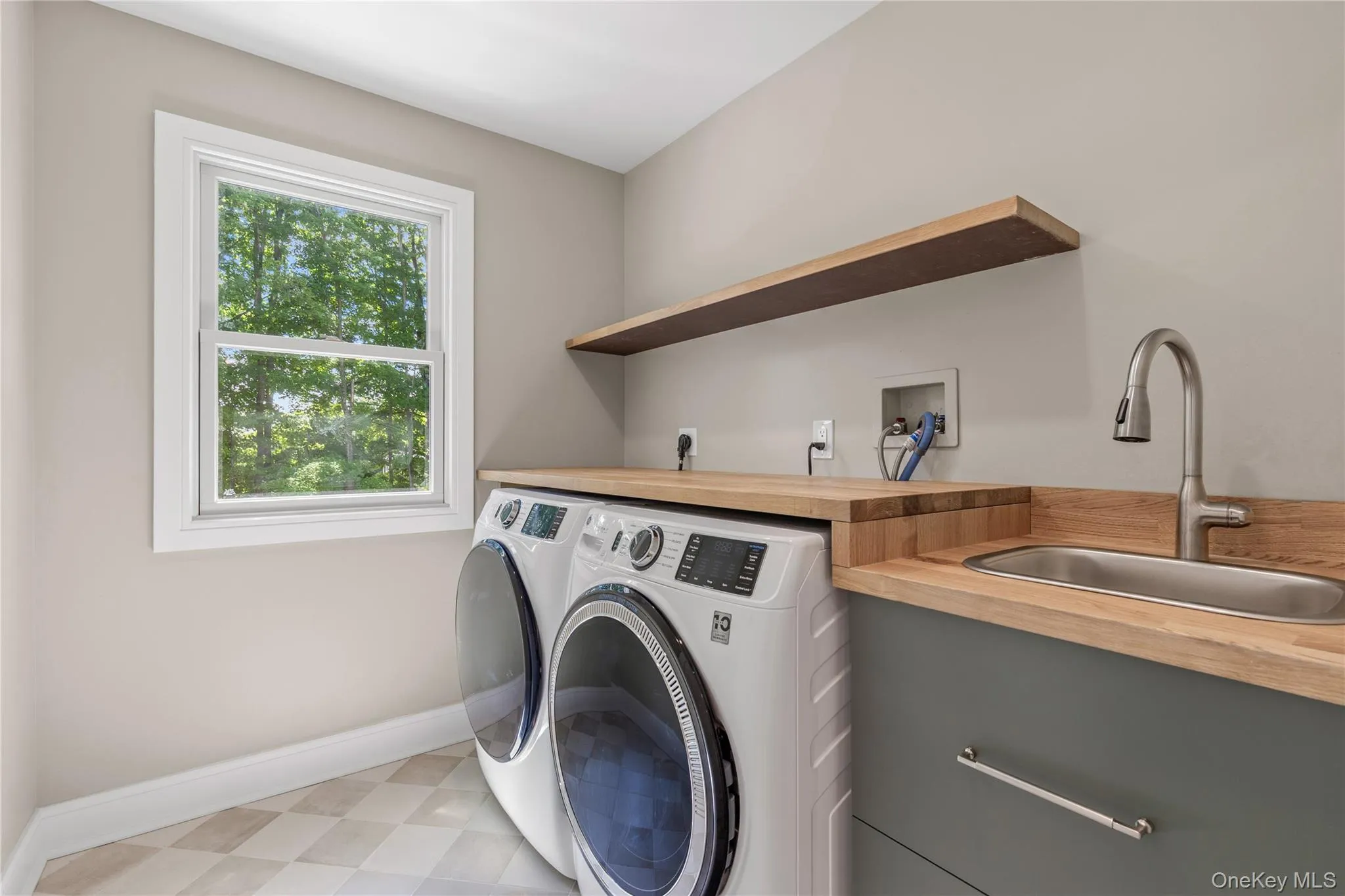 Laundry with Washer, Dryer, Sink and Storage. Laundry with Washer, Dryer, Sink and Storage.