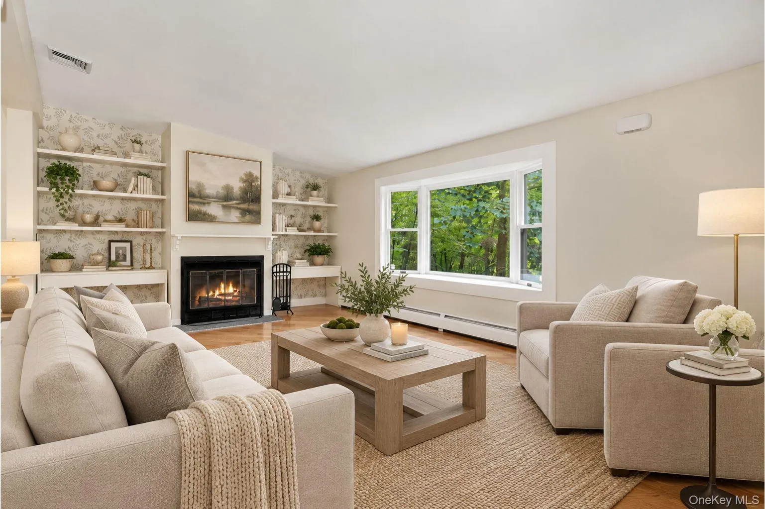 Open concept living room with large bay window, fireplace and built-in shelving. Virtually staged. Open concept living room with large bay window, fireplace and built-in shelving. Virtually staged.
