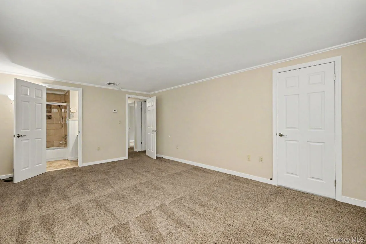 Large primary bedroom with walk in closet. Large primary bedroom with walk in closet.