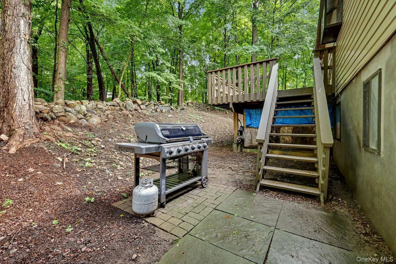 Lower level BBQ area off back deck. Lower level BBQ area off back deck.