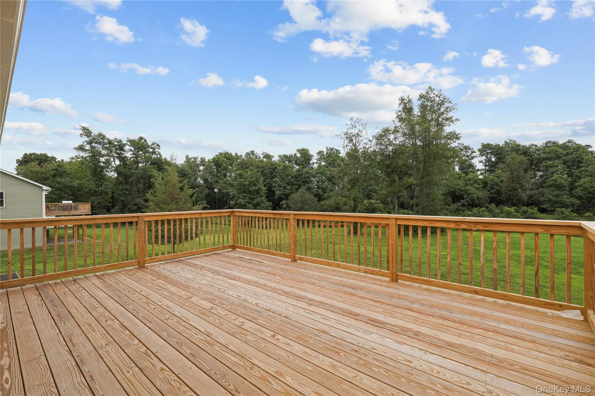 Spacious Deck Overlooking the Large Backyard – Perfect for Outdoor Living Spacious Deck Overlooking the Large Backyard – Perfect for Outdoor Living