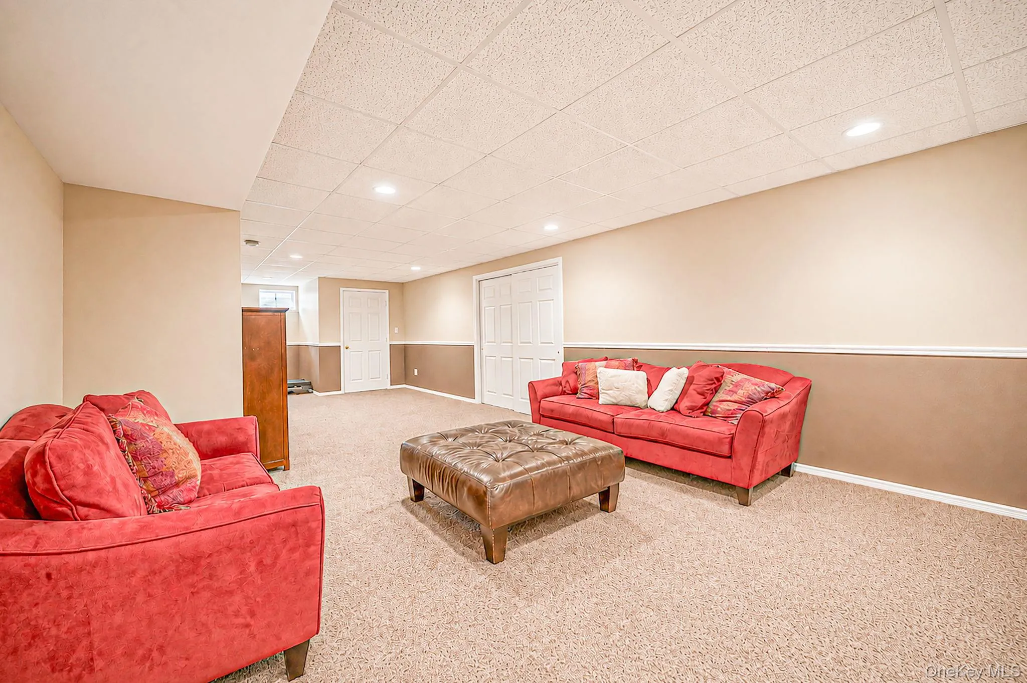 Recessed lighting, carpet flooring, two-tone wall paint, white trim, and white paneled doors Recessed lighting, carpet flooring, two-tone wall paint, white trim, and white paneled doors