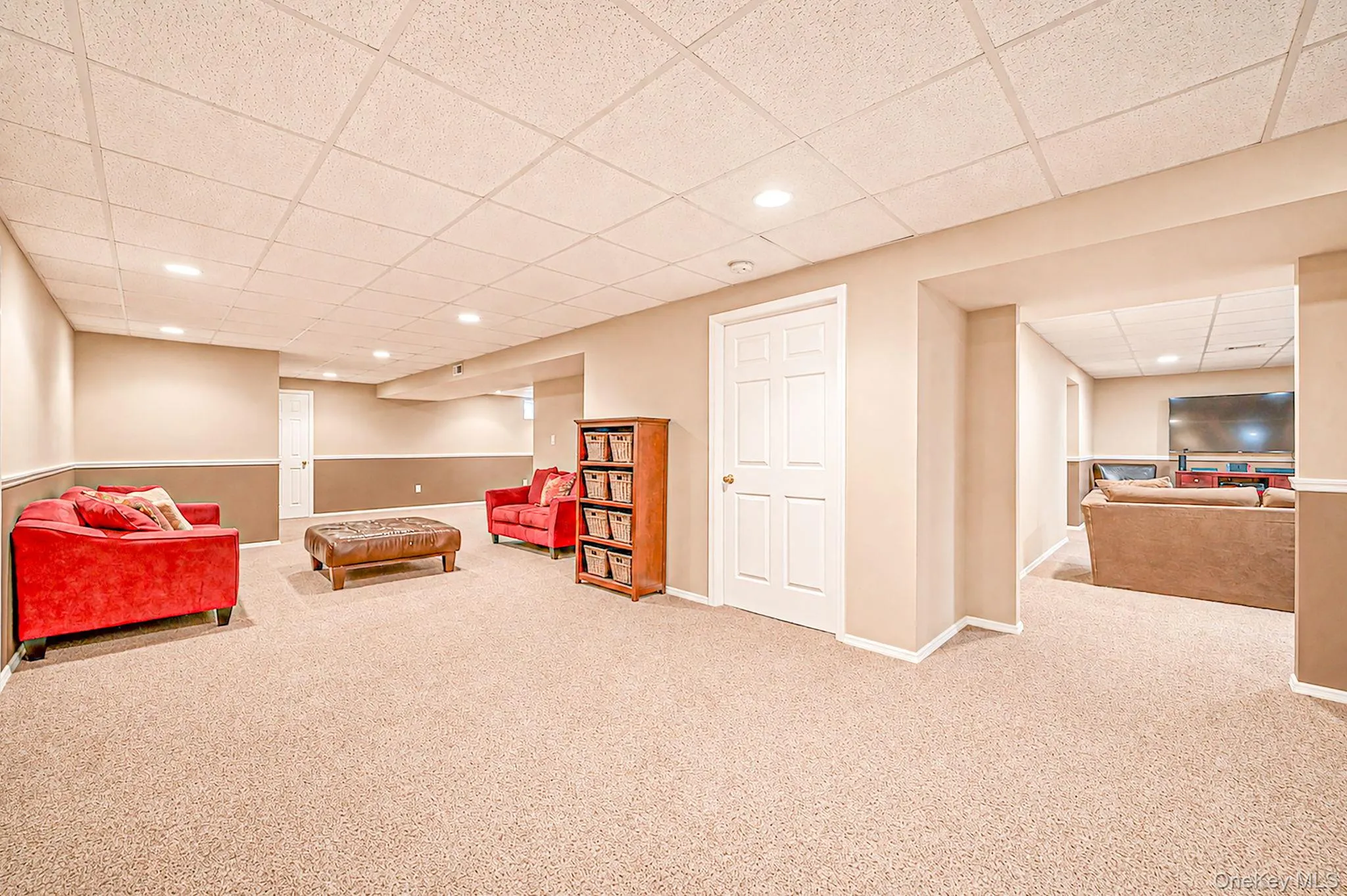 Recessed lighting, carpet flooring, two-tone wall paint, white trim, and white paneled doors Recessed lighting, carpet flooring, two-tone wall paint, white trim, and white paneled doors