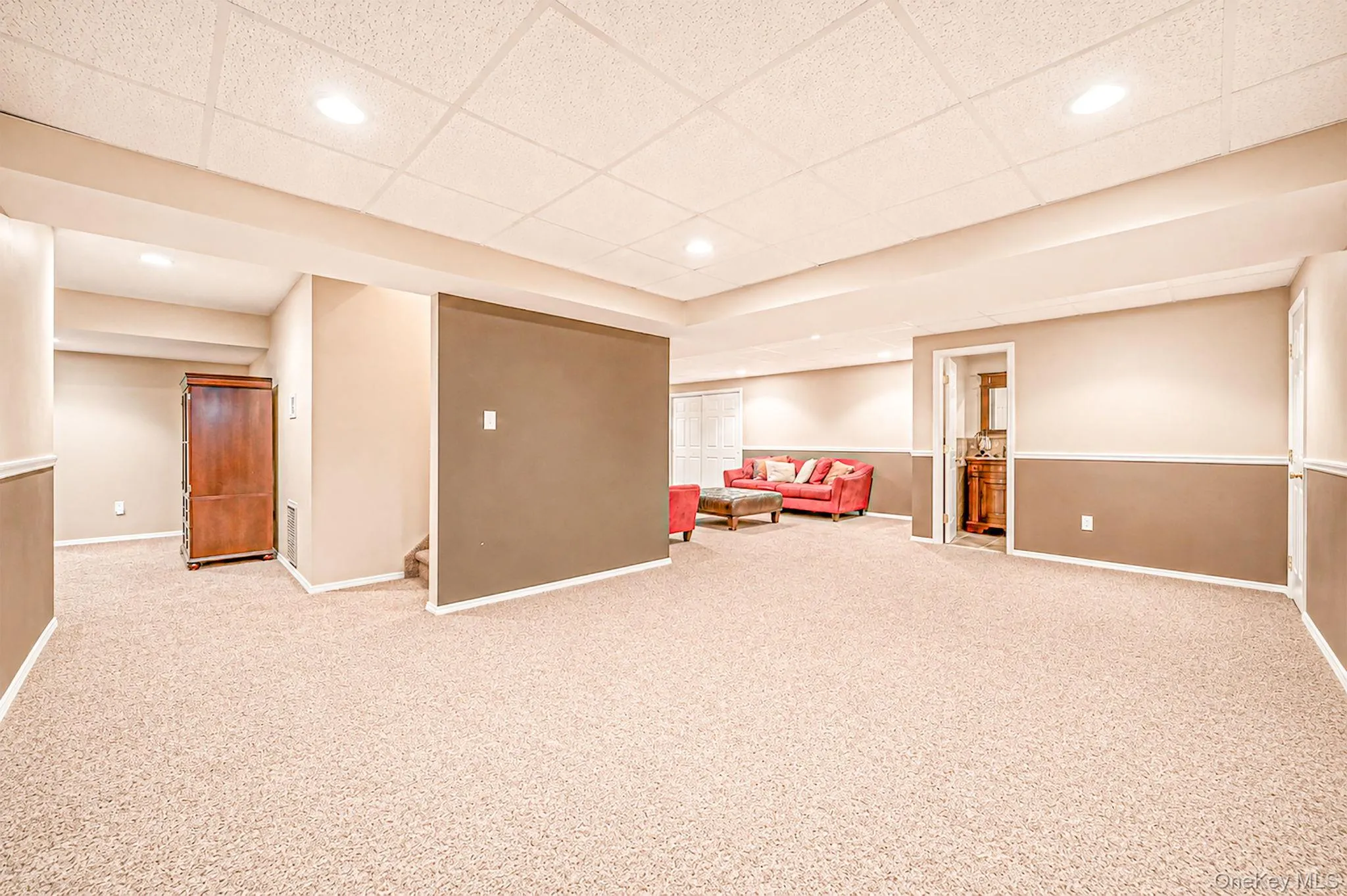 Recessed lighting, carpet flooring, two-tone wall paint, white trim Recessed lighting, carpet flooring, two-tone wall paint, white trim