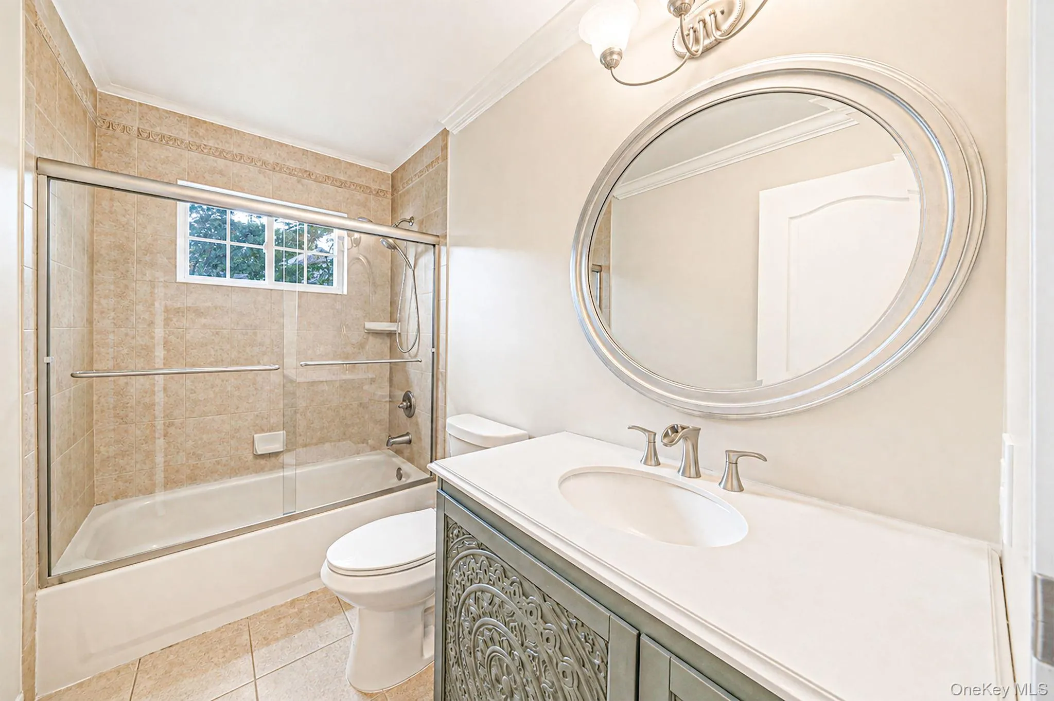 White vanity countertop with an integrated sink, brushed nickel faucet, and an oval framed mirror White vanity countertop with an integrated sink, brushed nickel faucet, and an oval framed mirror
