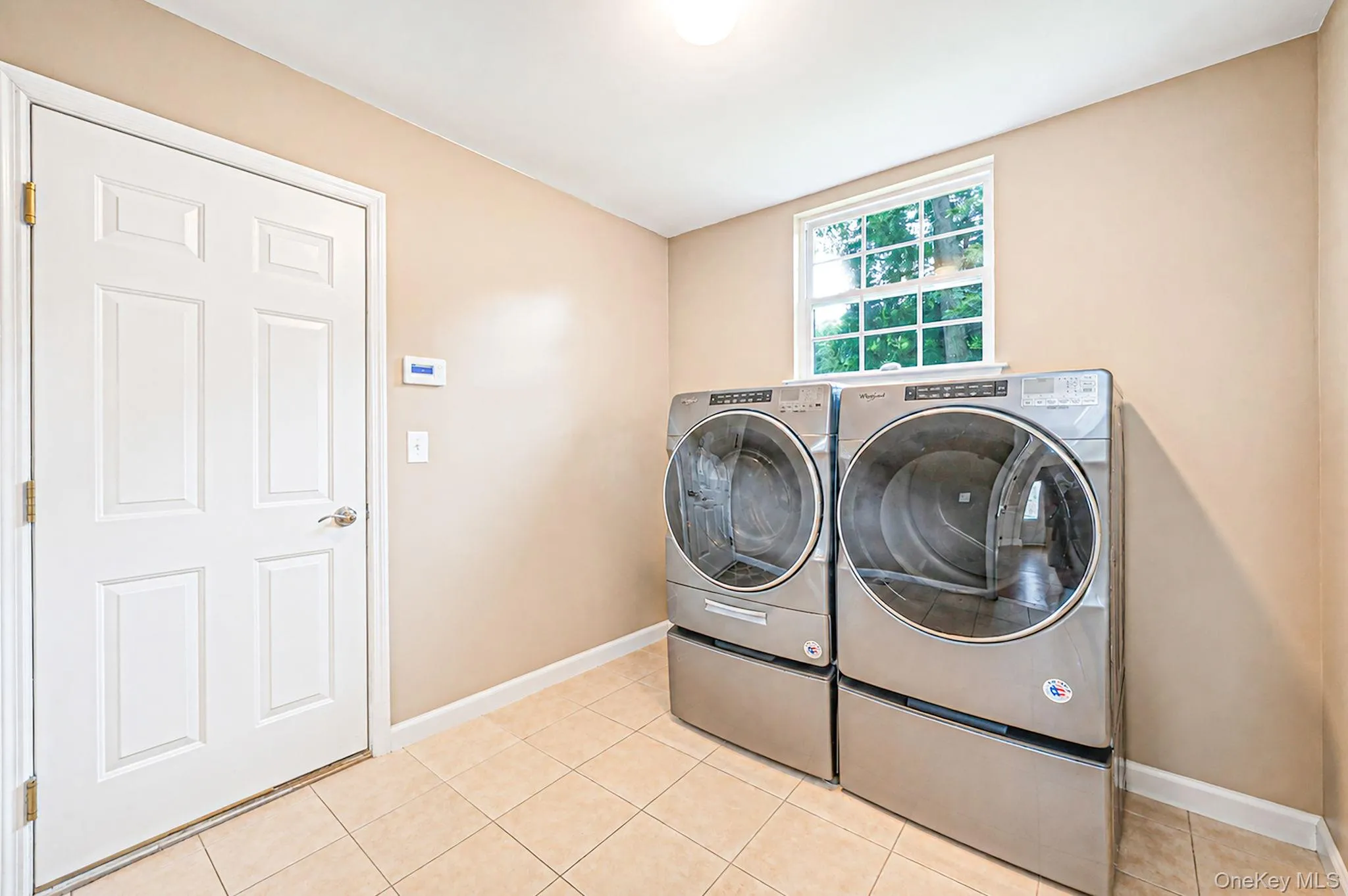 Laundry area featuring tile flooring Laundry area featuring tile flooring