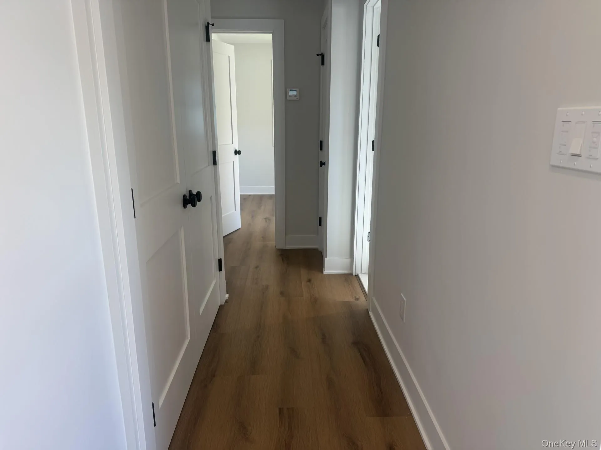 Hallway to Laundry, Bathroom, Bedroom, and Primary Suite Hallway to Laundry, Bathroom, Bedroom, and Primary Suite