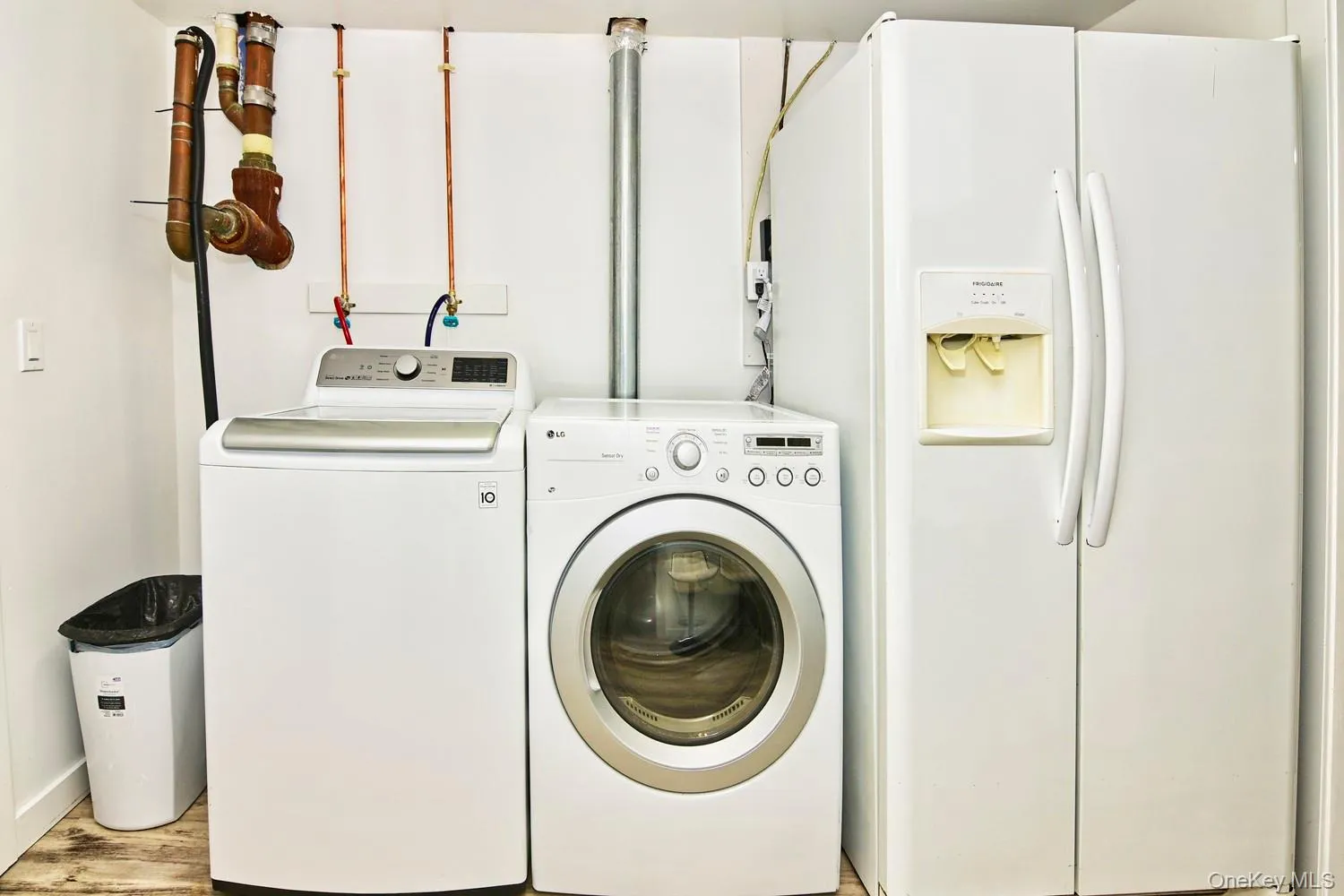 White side-by-side refrigerator, top-load washing machine, and front-load washing machine