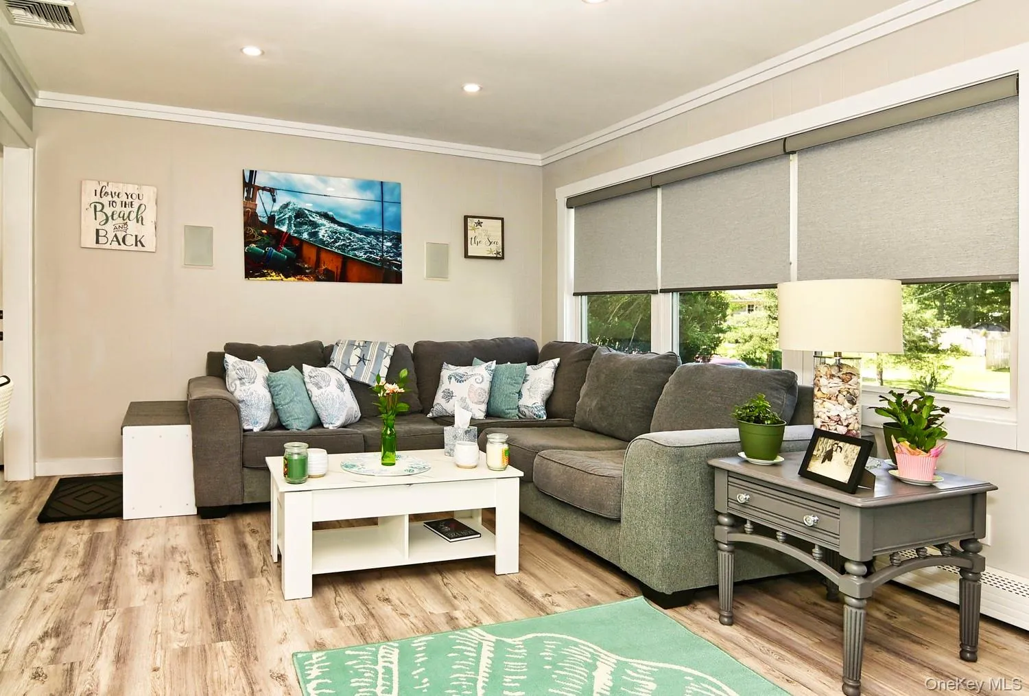 Wood-finish flooring throughout, recessed lighting, and crown molding