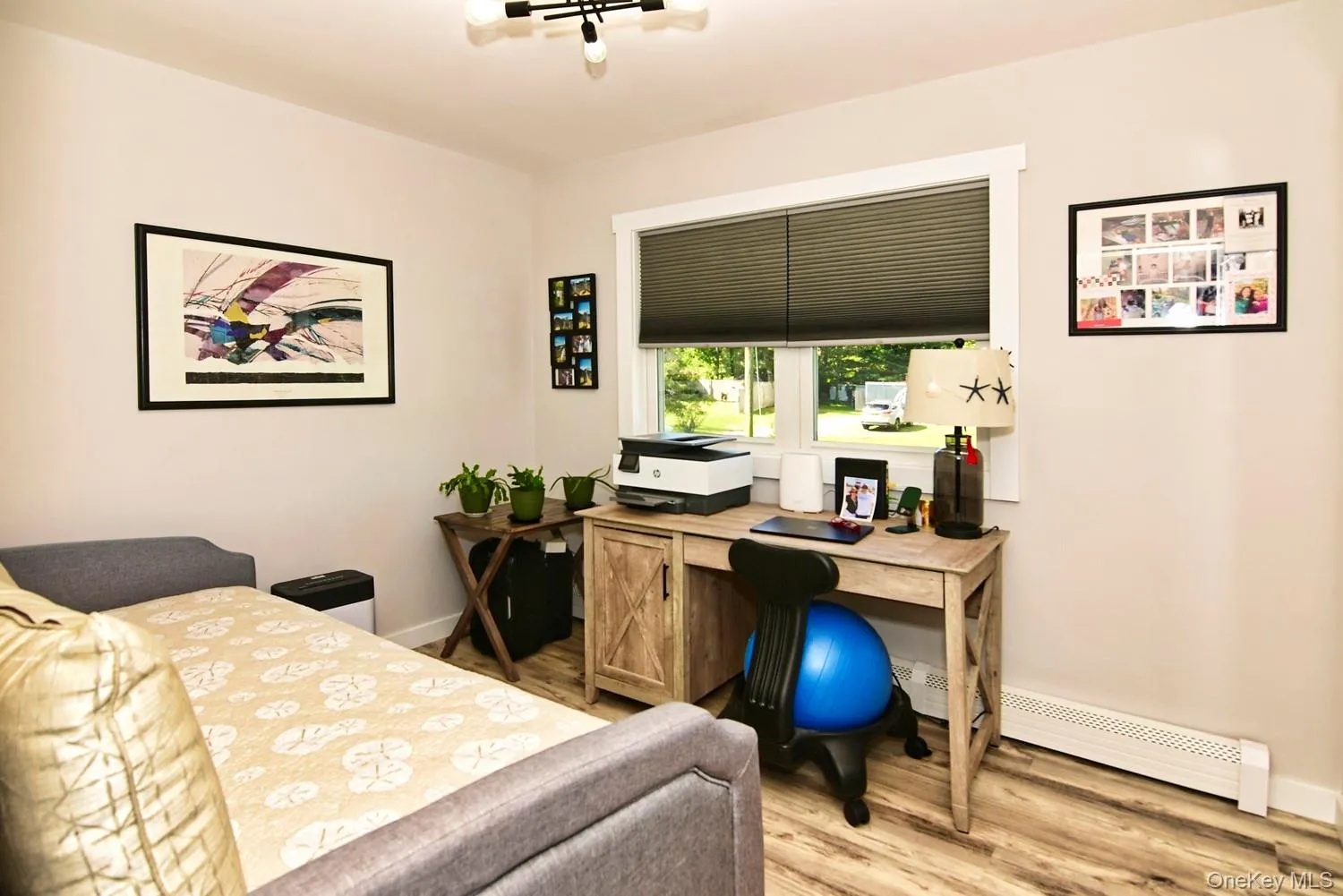 Neutral wall tones, wood-finish flooring, and a window with blinds