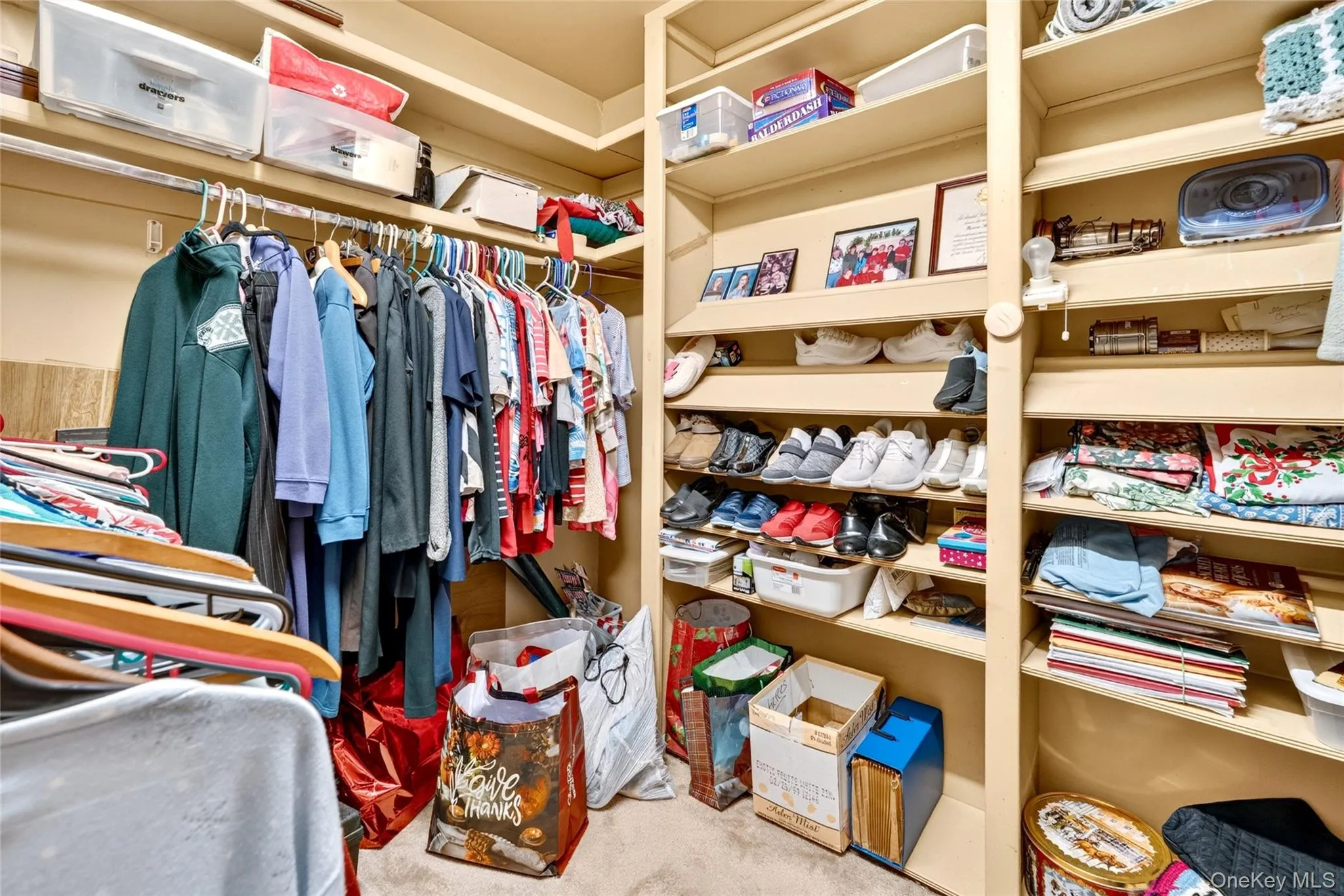 Large walk-in closet with extensive built-in shelving. Large walk-in closet with extensive built-in shelving.