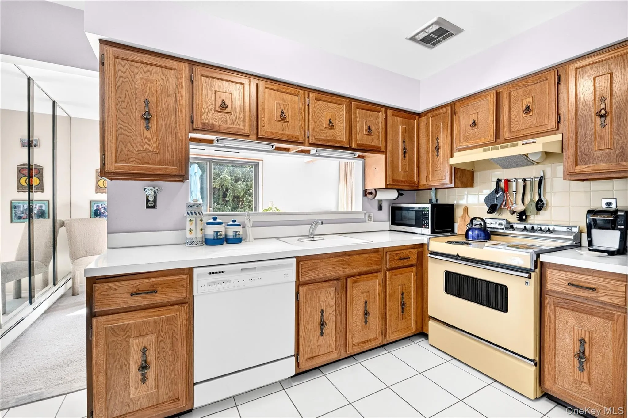 Kitchen with pass-through to the dining area. Kitchen with pass-through to the dining area.