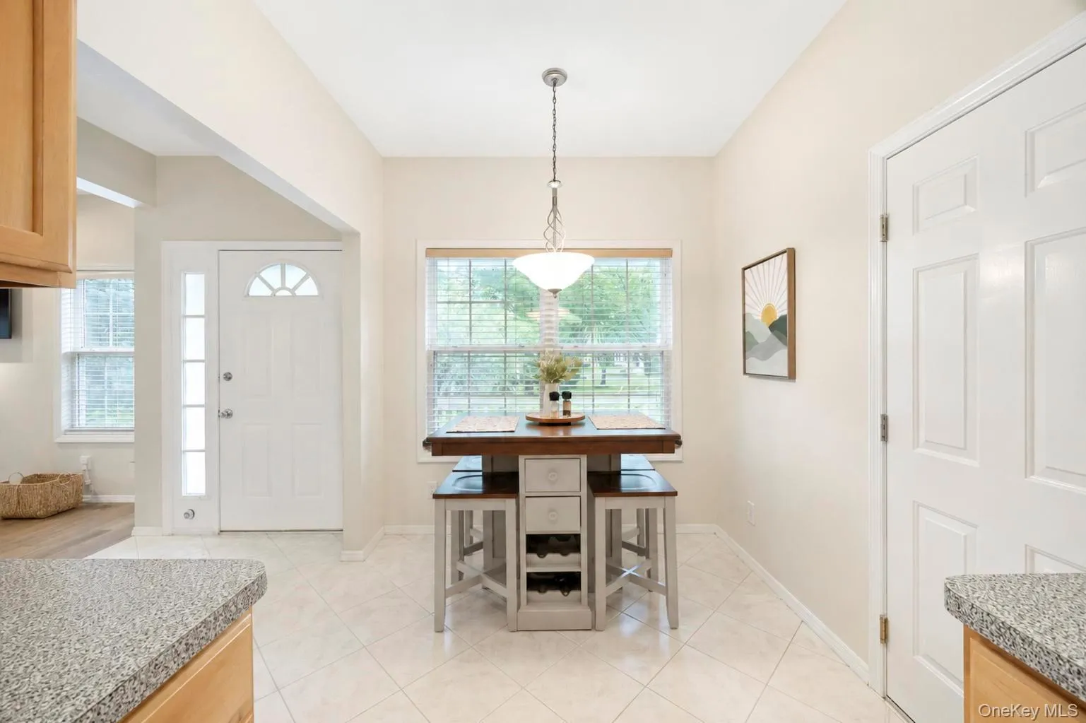 Eat in kitchen showing table with chairs and entrance foyer Eat in kitchen showing table with chairs and entrance foyer