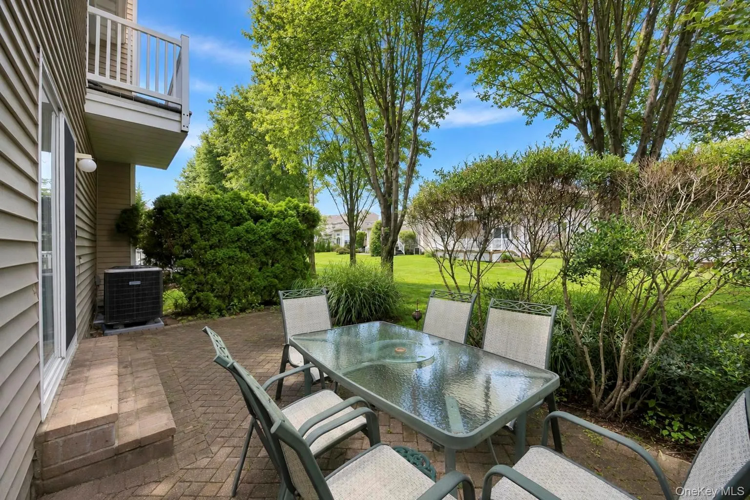 Paver patio with steps, exterior siding, and table area Paver patio with steps, exterior siding, and table area
