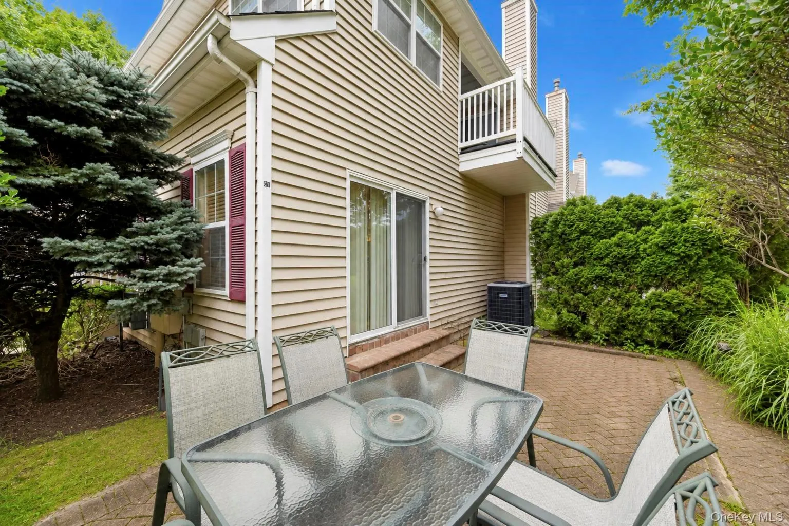 Private paver patio with a sliding glass door Private paver patio with a sliding glass door