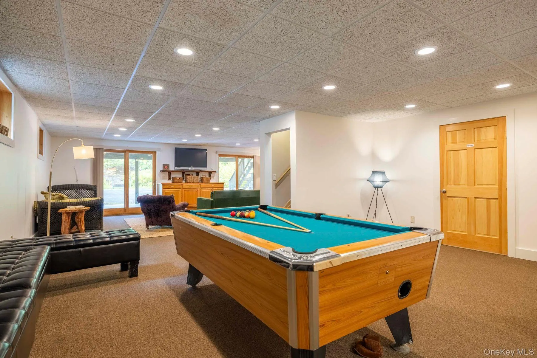 Additional recreation space with pool table, adjoining the main lower-level living area. Additional recreation space with pool table, adjoining the main lower-level living area.