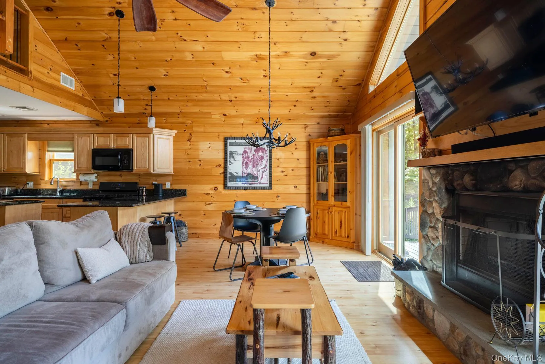 Great room with cathedral ceiling and wood burning fireplace Great room with cathedral ceiling and wood burning fireplace