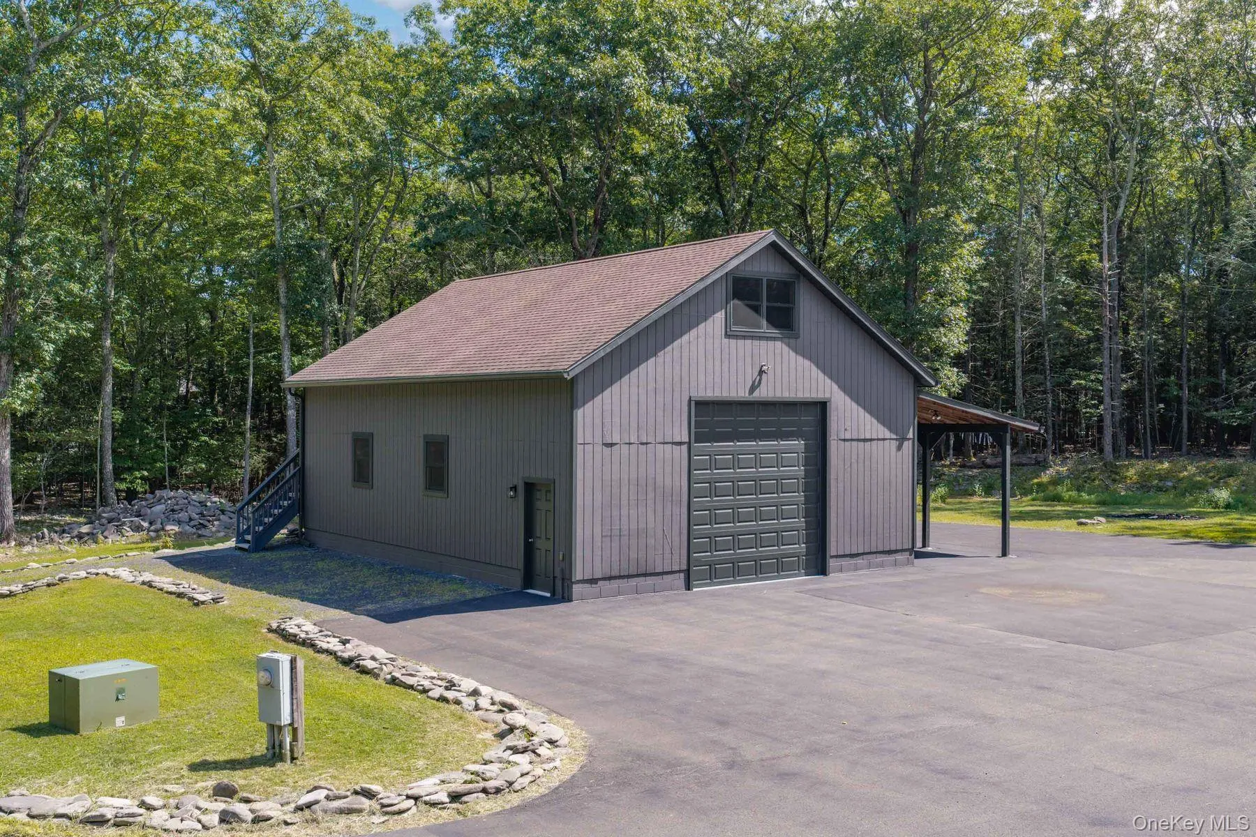 Versatile detached garage/workshop with space for RV storage, a half bath, and unfinished upper-level space with separate exterior access offering potential for future finishing. Versatile detached garage/workshop with space for RV storage, a half bath, and unfinished upper-level space with separate exterior access offering potential for future finishing.